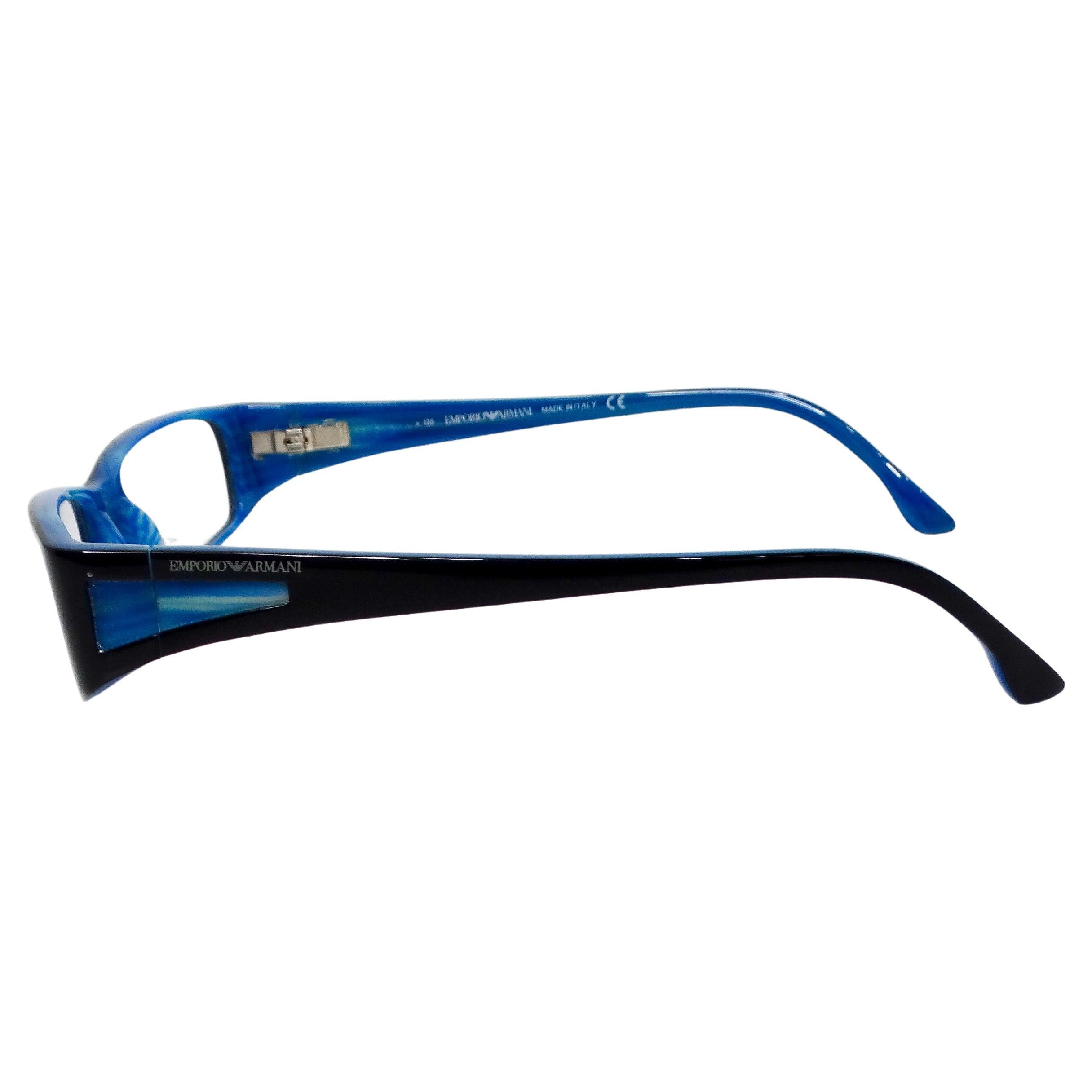 The Emporio Amani Blue & Black Handmade Acetate Rectangular Frame Sunglasses circa Y2K embody a distinctive blend of vintage charm and modern sophistication. Featuring a bold rectangular shape, these sunglasses showcase a striking contrast with