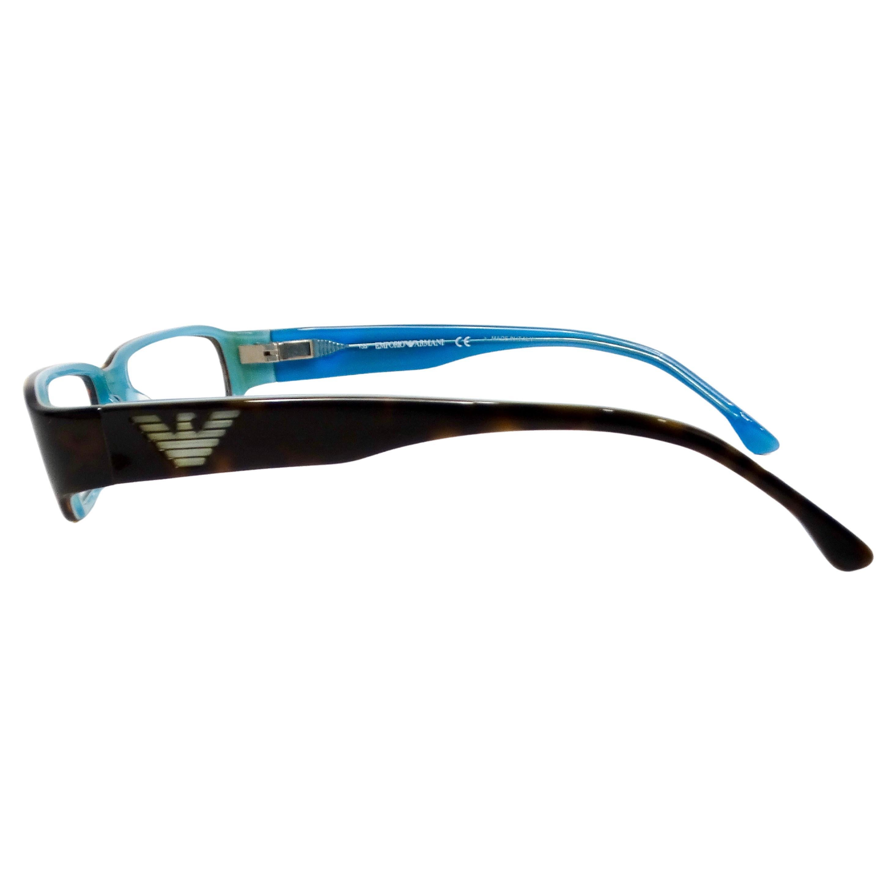 The Emporio Amani Blue & Black Handmade Acetate Rectangular Sunglasses from the Y2K era are a striking blend of vintage-inspired design and contemporary sophistication. Crafted with meticulous attention to detail, these sunglasses feature a classic