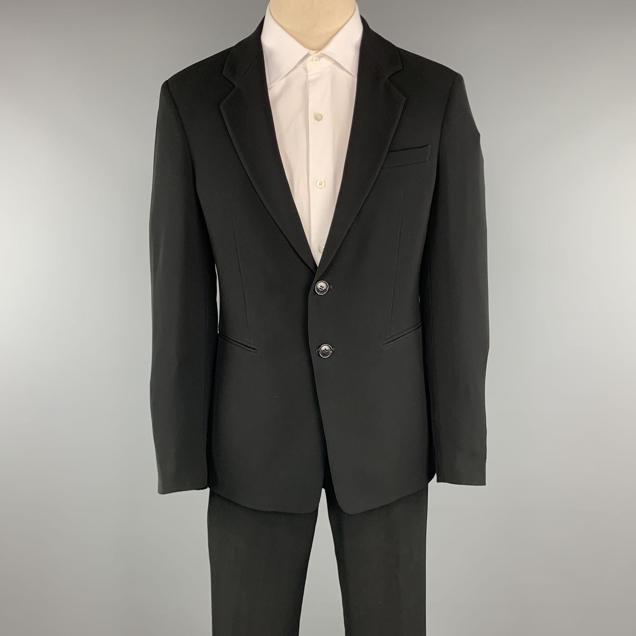 EMPORIO ARMANI Suit comes in black polyester and includes a single breasted, two button sport coat with notch lapel and matching front trousers. Made in Italy.
Excellent Pre-Owned Condition.
Marked: 48

Measurements:

-Jacket
Shoulder: 17.5 in.