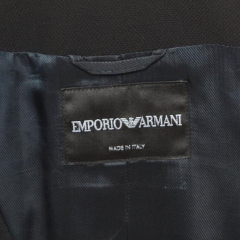 Scegli una sartoria sofisticata con questo tailleur pantalone di Emporio Armani. Questo modello in cotone nero abbina un pantalone classico a una camicetta con bottoni. Abbina l'abito alle tue décolleté preferite e alla tote per la prossima riunione.
