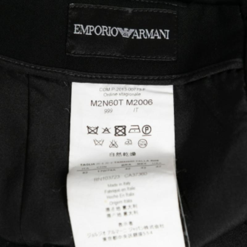 This skirt from Emporio Armani will deliver a sense of femininity and class to your attire. Made from black crepe fabric, this skirt features pleated detailing and a zipper for fastening. It accommodates two pockets. Match this skirt with your