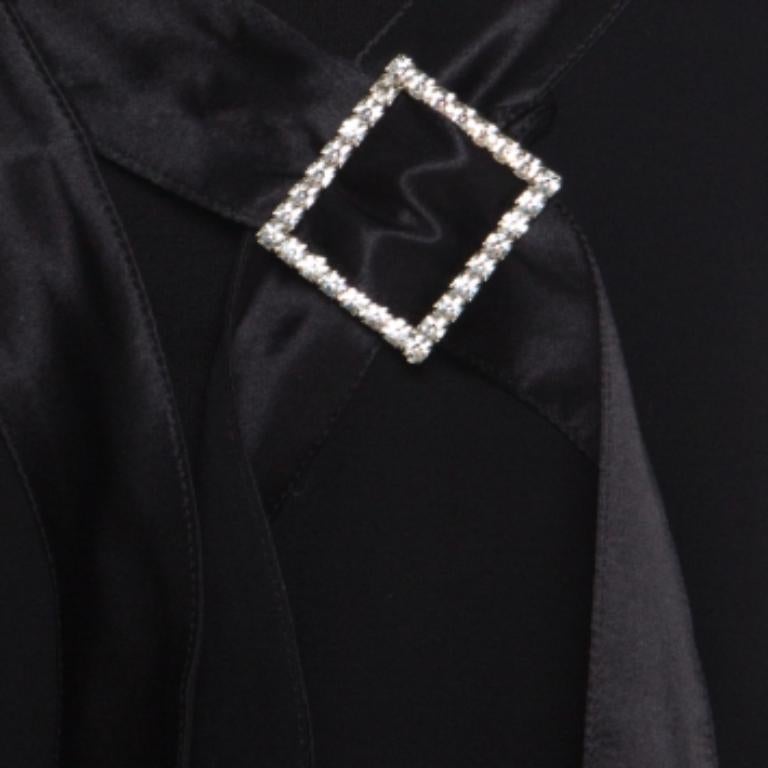 This blouse from Emporio Armani will stand out and worth every cent you invest. It is made of 100% silk and the front closure features an embellished buckle. It also flaunts a loose fit and short sleeves. Balance the sheer style by wearing a