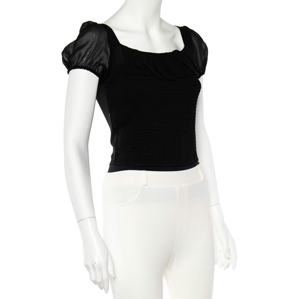 Impress everyone with this gorgeous top from Emporio Armani. This attractive top has a touch of modernity in its design that projects its versatility. Made from rich silk, it has smocked details, a sheer appearance and a fitted silhouette. 
