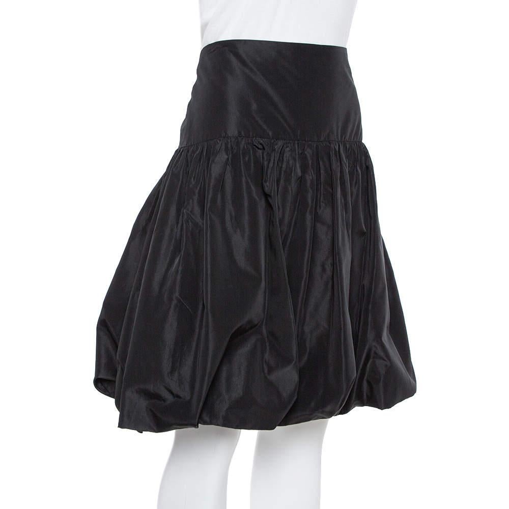 Stylish and playful, this feminine skirt comes from the house of Emporio Armani. It has been crafted from quality taffeta and comes in a classic shade of black. The versatile hue combined with the gathered silhouette make this short skirt a