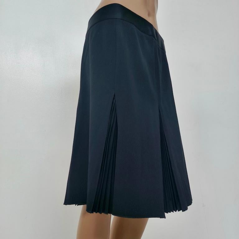 What makes it unique or special? Armani hides four razor-sharp knife pleats behind smooth panels, so the skirt looks perfectly minimal when you stand still, then fans open only in movement for a sudden flare. You get the swing of a fully pleated