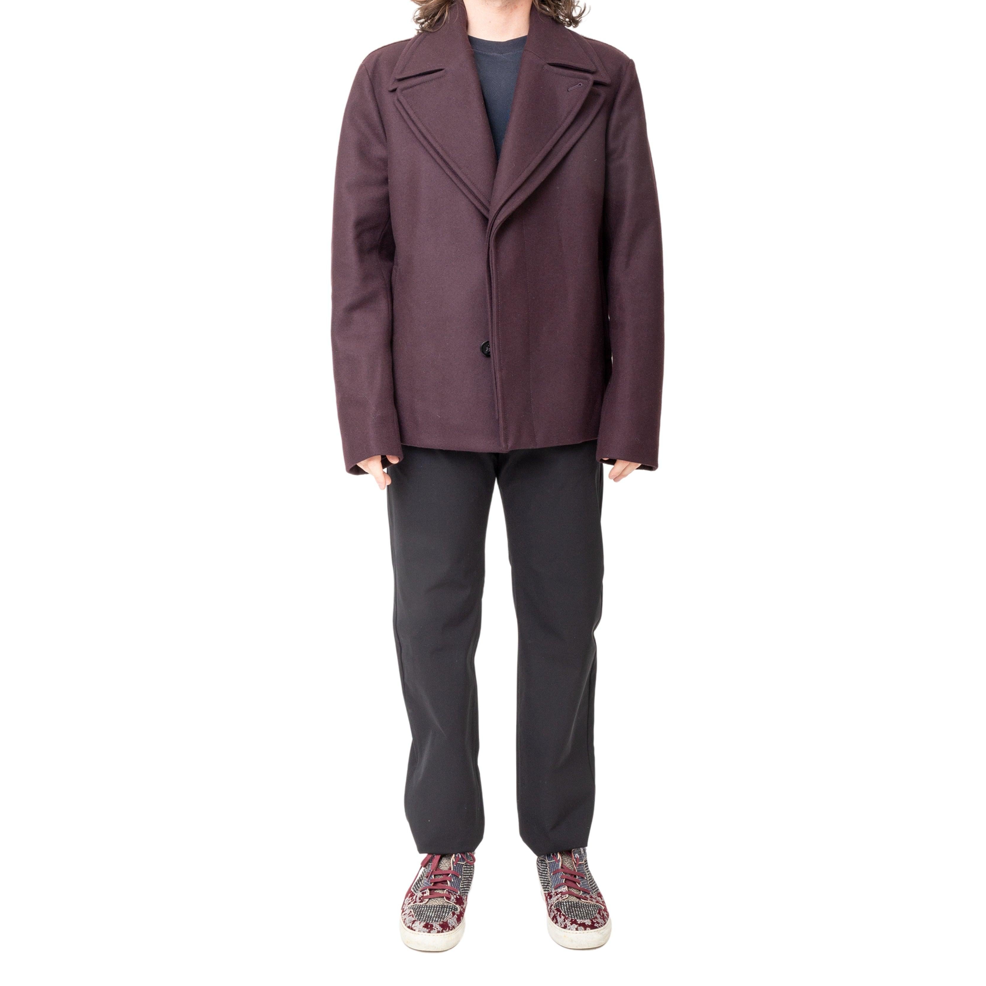 The Emporio Armani Double Collar Jacket is a must-have for your winter wardrobe. Crafted in a deep purple wool blend, this jacket features a unique double collar and a removable inside layer for versatility. The back is adorned with a luxurious faux
