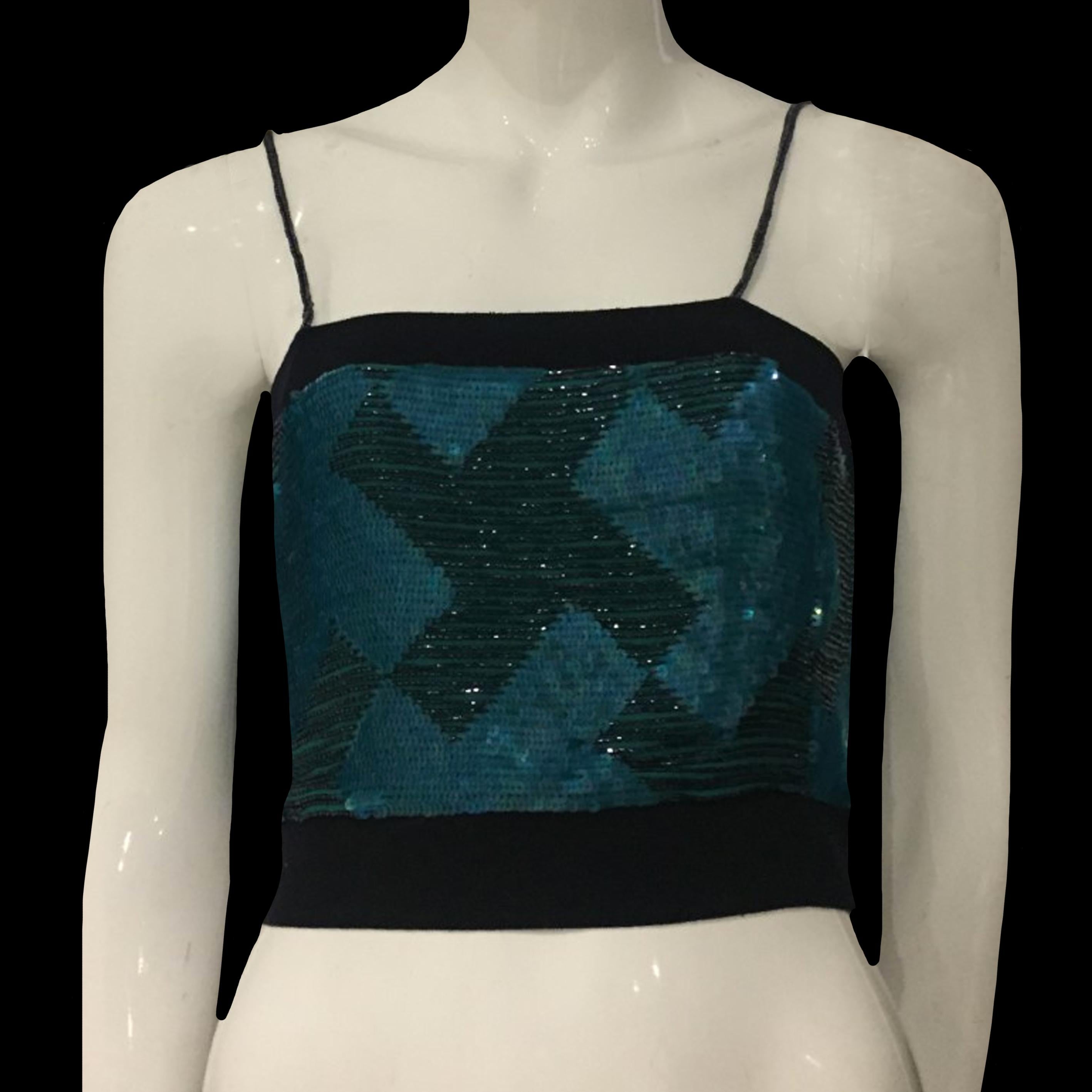 EMPORIO ARMANI FW2002 Turquoise sequins silk top with black pearls

Tag EMPORIO ARMANI

Size S
Chest 32cm
Length 40cm

Zip on the side

Perfect condition

Shipping worldwide with tracking number