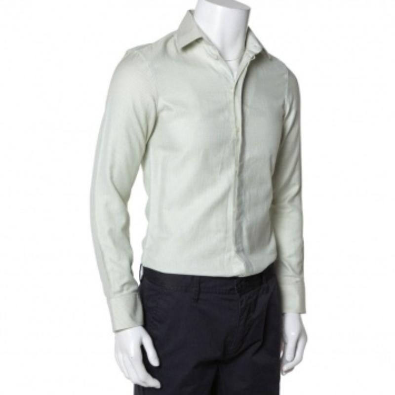 Comfortable clothing brought to you by Emporio Armani. This light green shirt is tailored using cotton into a simple casual design and finished with a buttoned collar, long sleeves, and full front buttons. The shirt offers a great fit.