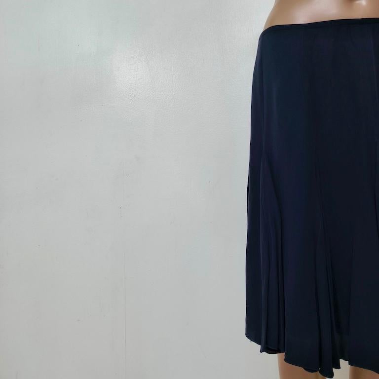 What makes this product unique or special?
Emporio Armani transforms the classic pleated skirt into a modern minimalist piece. Four razor-sharp knife pleats are hidden behind smooth panels, so the skirt appears perfectly sleek when you stand still,
