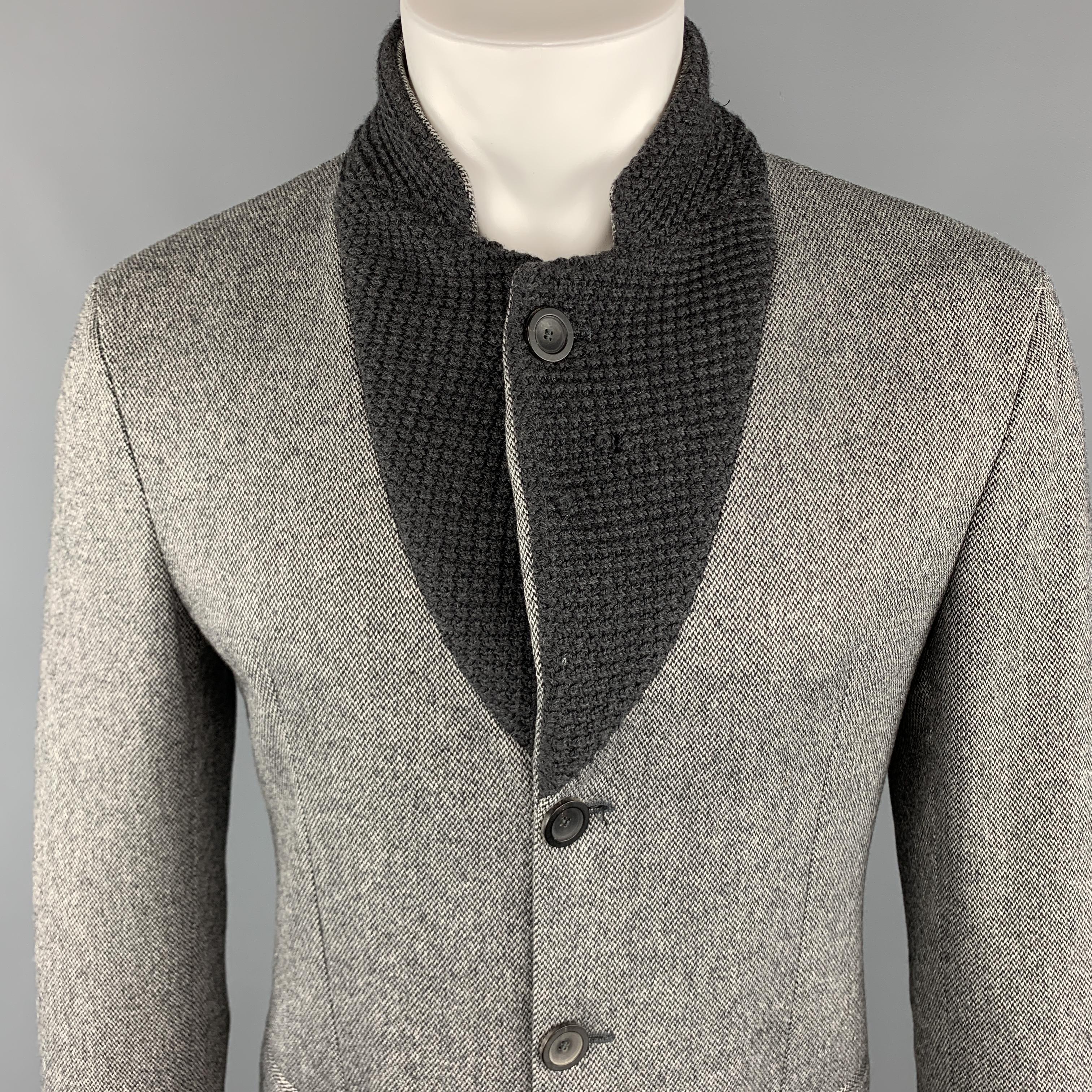 EMPORIO ARMANI MR A Line Jacket comes in a gray tone in a heather wool blend material, with a notch knitted lapel, slit pockets, 3/4 buttons at closure, single breasted, unbuttoned cuffs. Minor tear at knit inside lapel. Made in Italy.

Very Good