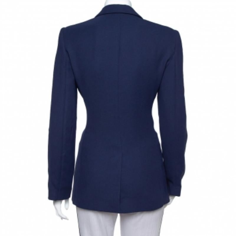 This tailored blazer from Emporio Armani is sure to make you look your best from every angle. The navy blue blazer is made of crepe and features clean-cut lapels and pockets. Wear it for your formal meetings and you are sure to leave a fashionable