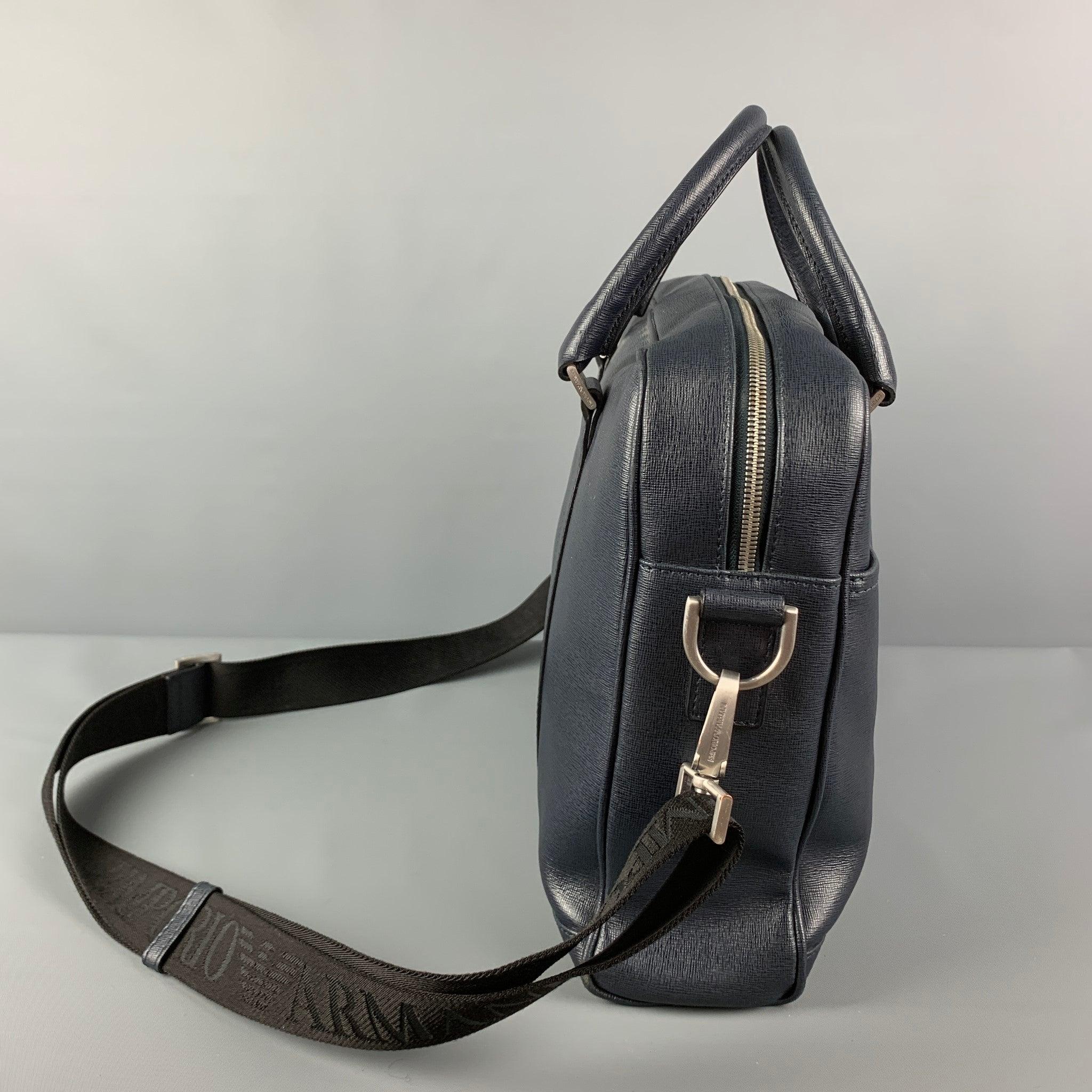 EMPORIO ARMANI bag comes in a navy textures saffiano leather featuring a briefcase style, detachable crossbody strap, top handles, silver tone hardware, front pockets, interior pocket, and a zipper closure. Made in Italy.
Very Good
Pre-Owned