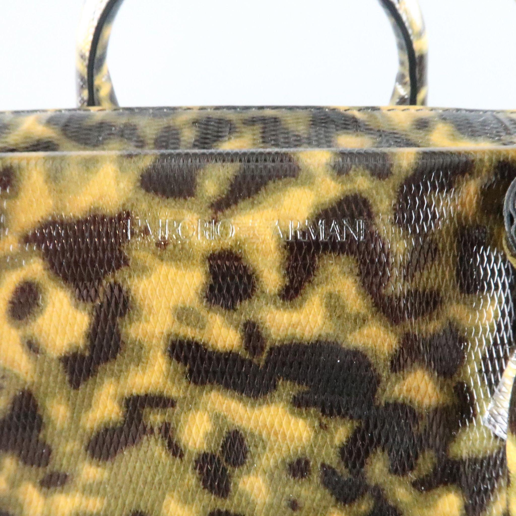 EMPORIO ARMANI briefcase comes in a unique camouflage tortoiseshell textured patent leather and features double covered top handles, two zip compartments with an internal adjustable zip, and storage pockets in liner. Includes optional shoulder