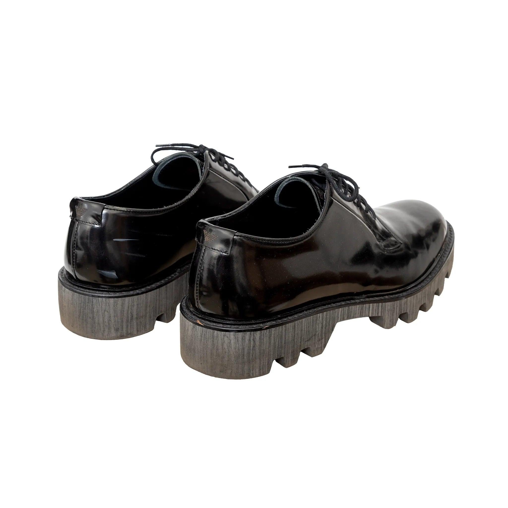 Zapatos Oxford Emporio Armani de piel negra brillante con sutil plataforma, diseño con cordones y detalle del logotipo de la firma en el tobillo. Observaciones: La talla no está indicada, se ajusta como una EU 44. Hay algunos arañazos. 
 Material: