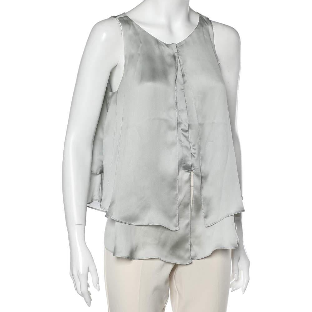 Easy to pair with skirts, jeans, or tailored pants, this Emporio Armani sleeveless top ensures versatile styling options. It features a front button closure, a simple neckline, and layered details.