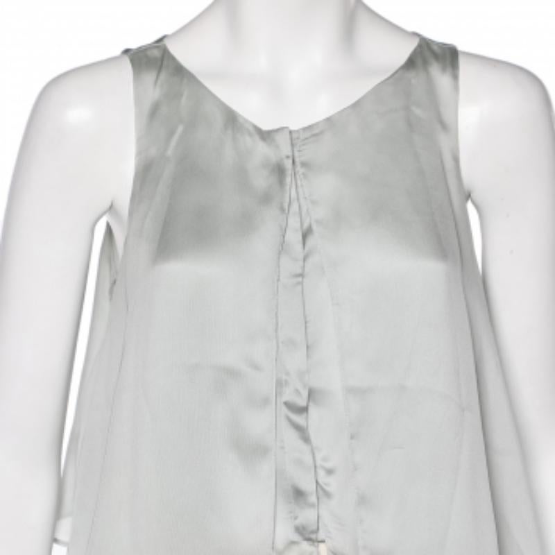 Easy to pair with skirts, jeans, or tailored pants, this Emporio Armani sleeveless top ensures versatile styling options. It features a front button closure, a simple neckline, and layered details.