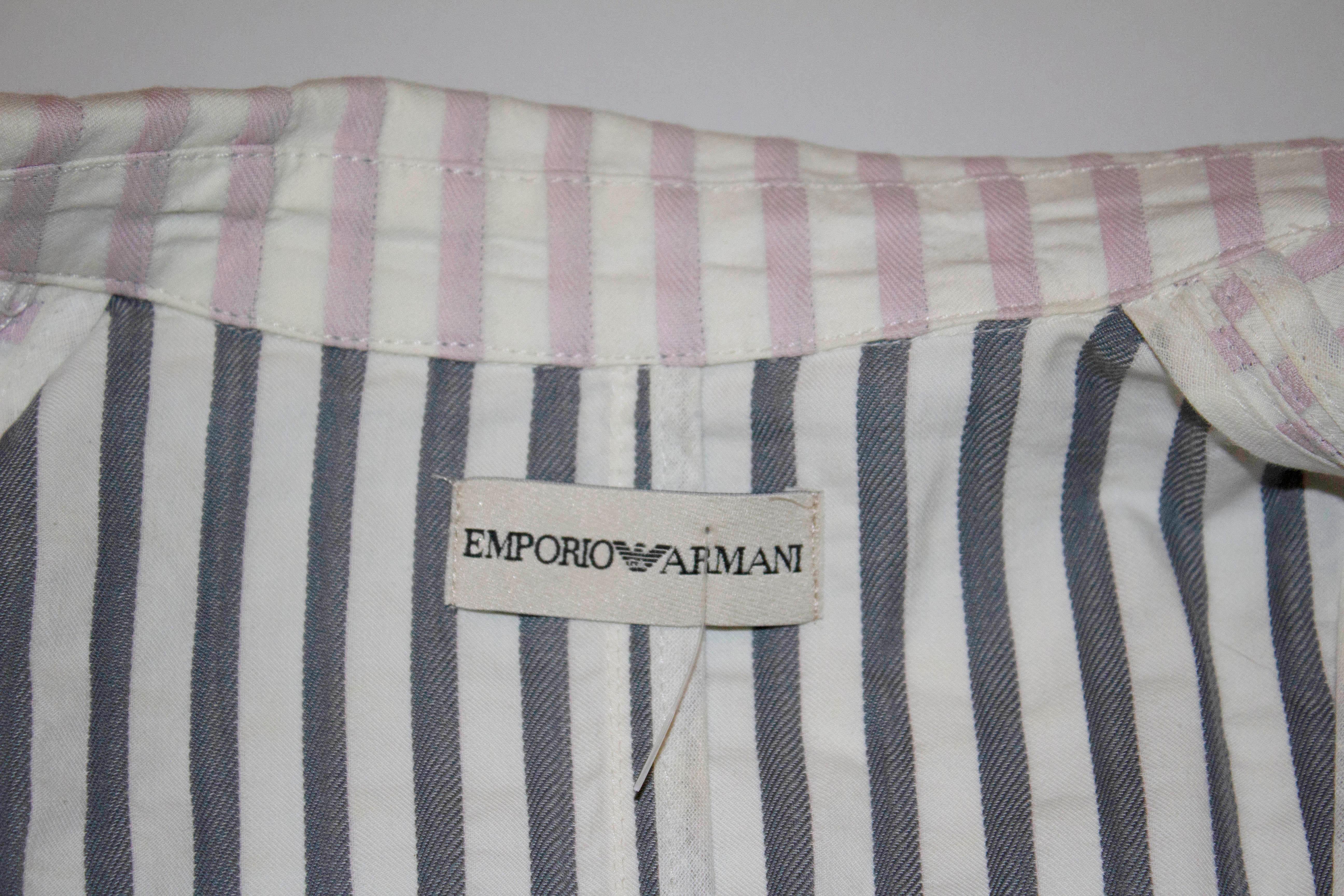 A great pink and white stripe jacket by Emporio Armani . The jacket has a cut away collar, great tailoring and a three button opeining. 100% cotton , size 38. Measurements  Bust 35'',length 22'