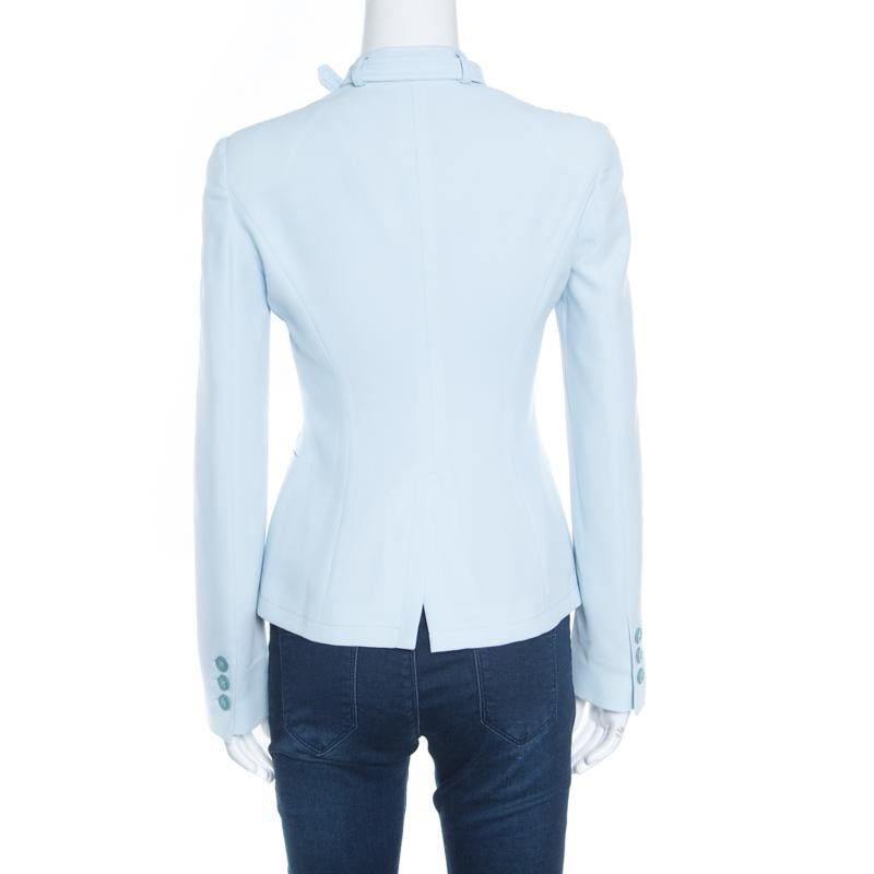 Chic and stylish, this powder blue blazer from Emporio Armani is made of bended fabric and features a feminine silhouette. It flaunts layered lapels accompanied a belted trim, button fastenings, two slip pockets, and a rear slit. You'll look lovely