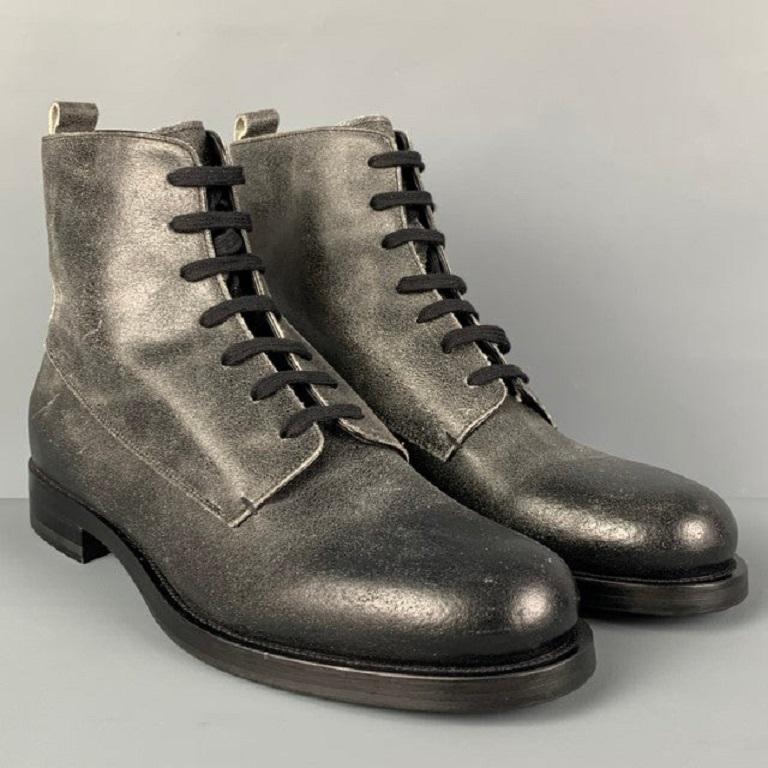 EMPORIO ARMANI ankle boots comes in a black distressed leather featuring a round toe and a lace up closure. Made in Italy.
Excellent
Pre-Owned Condition. 

Marked:   9 

Measurements: 
  Length: 12 inches  Width: 4.25 inches  Height: 6 inches 
  
 