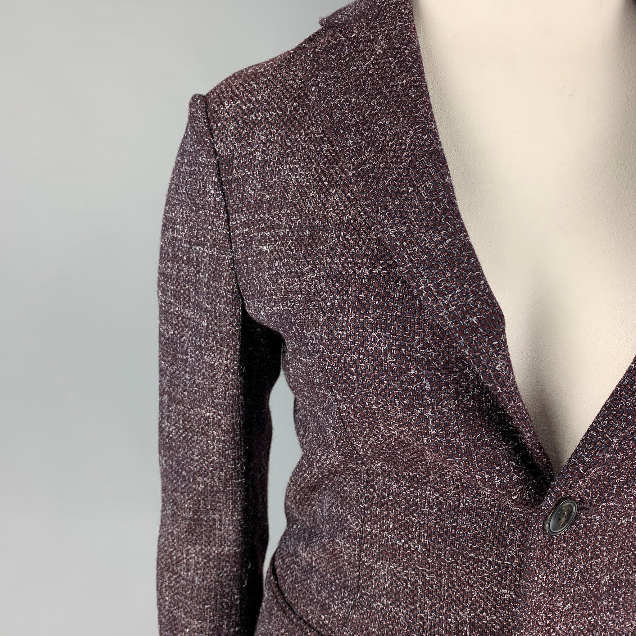 EMPORIO ARMANI blazer comes in a purple & grey heather material featuring a notch lapel, slit pockets, double back vent, and a double button closure.
Very Good
Pre-Owned Condition.
Fabric tag removed.  

Marked:   Size tag removed 

Measurements: 
