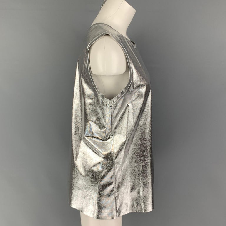 EMPORIO ARMANI top comes in a silver metallic lyocell blend featuring a crew-neck. 

New With Tags. 
Marked: 46

Measurements:

Shoulder: 13.5 in.
Bust: 40 in.
Length: 25 in. 