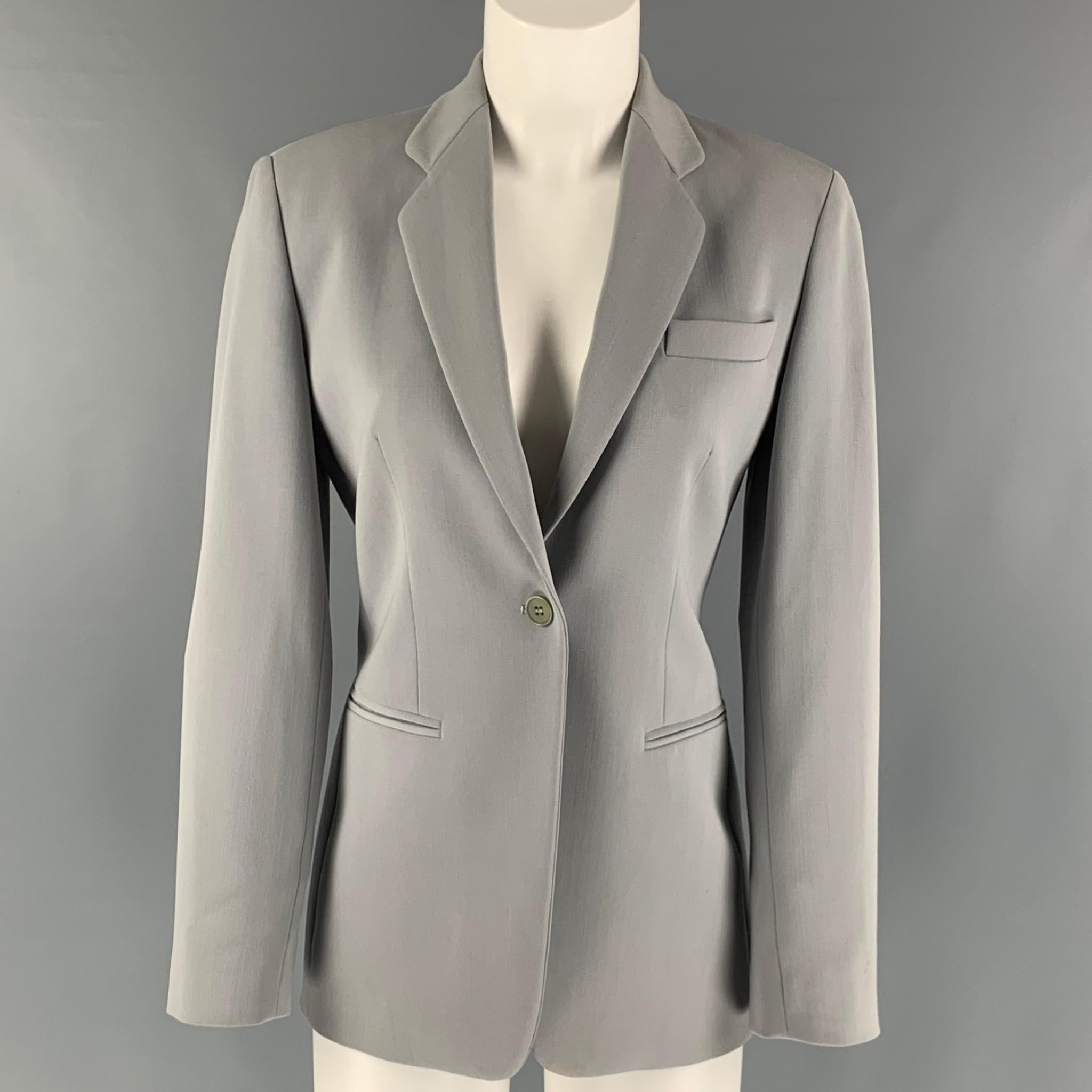EMPORIO ARMANI blazer comes in a grey mint polyester woven material with a full liner featuring a notch lapel, welt pockets, and a button closure. Made in Italy.

Very Good Pre-Owned Condition.
Marked: 38

Measurements:

Shoulder: 16 in.
Bust: 36