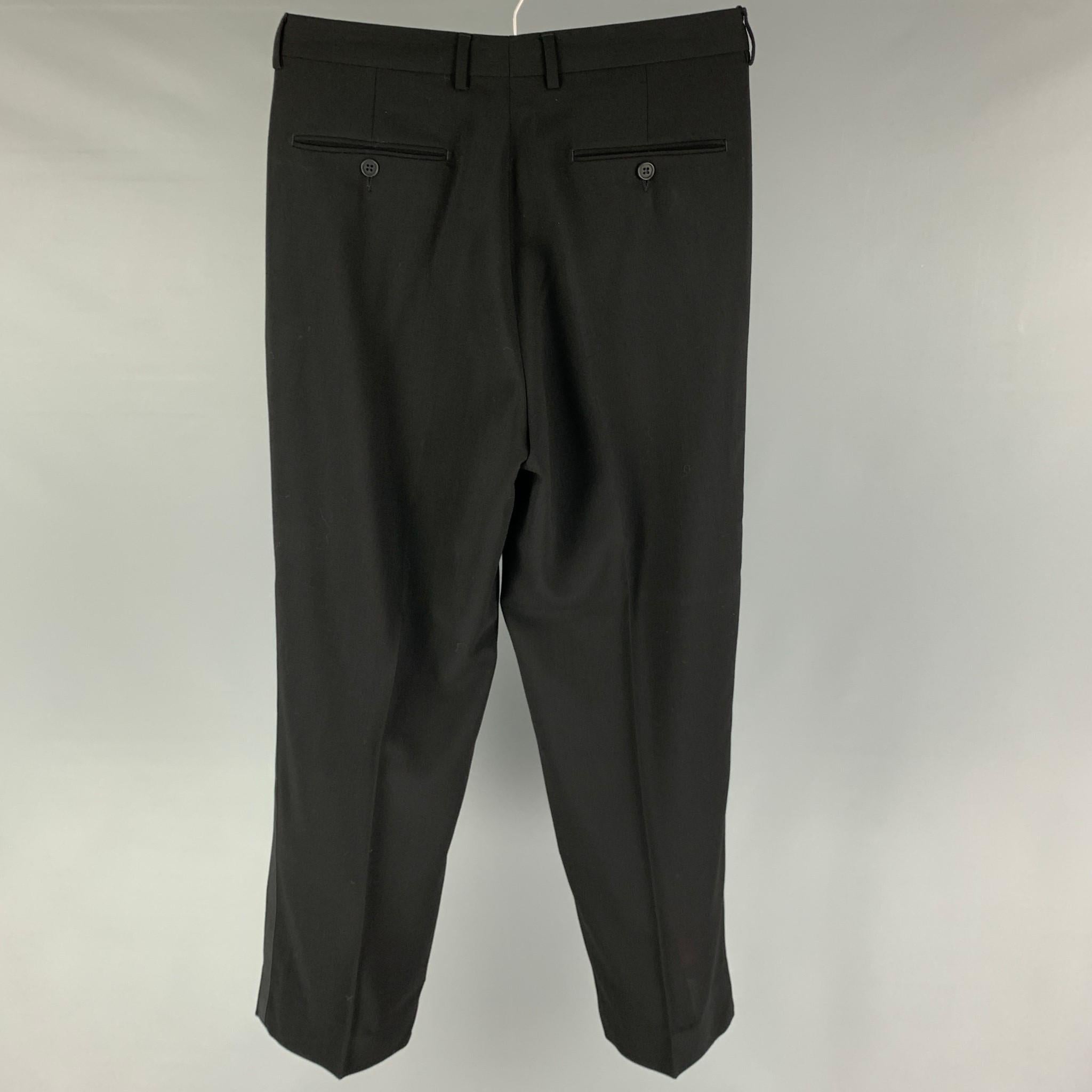 EMPORIO ARMANI tuxedo dress pants comes in a black wool featuring a pleated style, side stripe trim, and a zip fly closure. Made in Italy. 

Excellent Pre-Owned Condition.
Marked: 48

Measurements:

Waist: 30 in.
Rise: 12 in.
Inseam: 30 in.
Leg