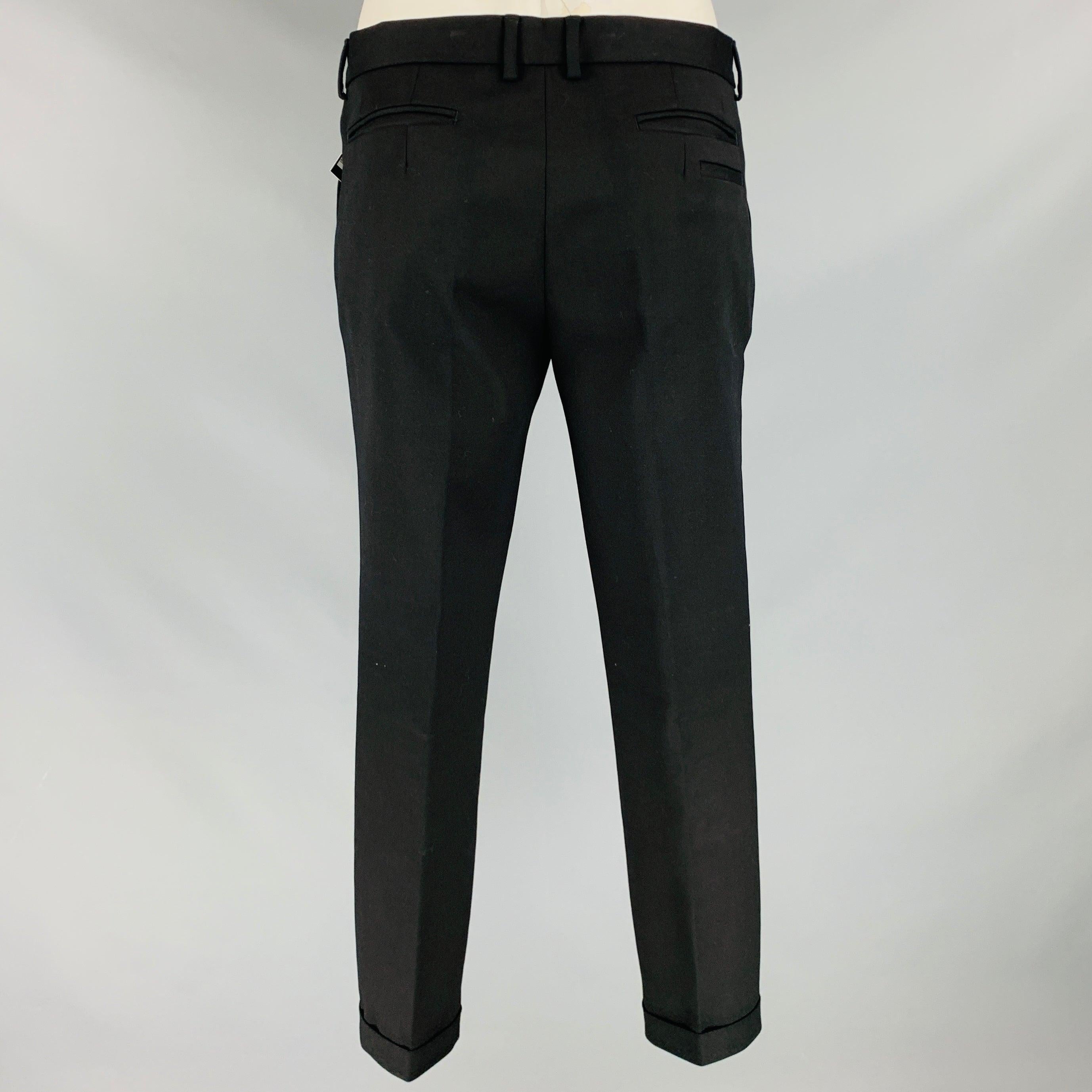 EMPORIO ARMANI dress pants
in a black cotton blend fabric featuring a cuffed style, zip pocket detail with signature logo pull, and zip fly closure. Made in Italy.Excellent Pre-Owned Condition. 

Marked:   IT 50 

Measurements: 
  Waist: 34 inches