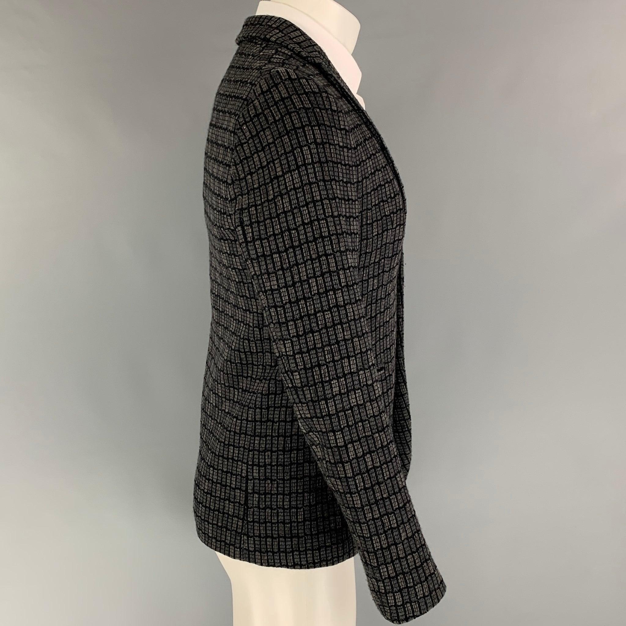 EMPORIO ARMANI sport coat comes in a grey & black knitted wool blend with a full liner featuring a notch lapel, slit pockets, and a double button closure. Made in Italy.
Very Good
Pre-Owned Condition.  

Marked:   44 

Measurements: 
 
Shoulder: 17
