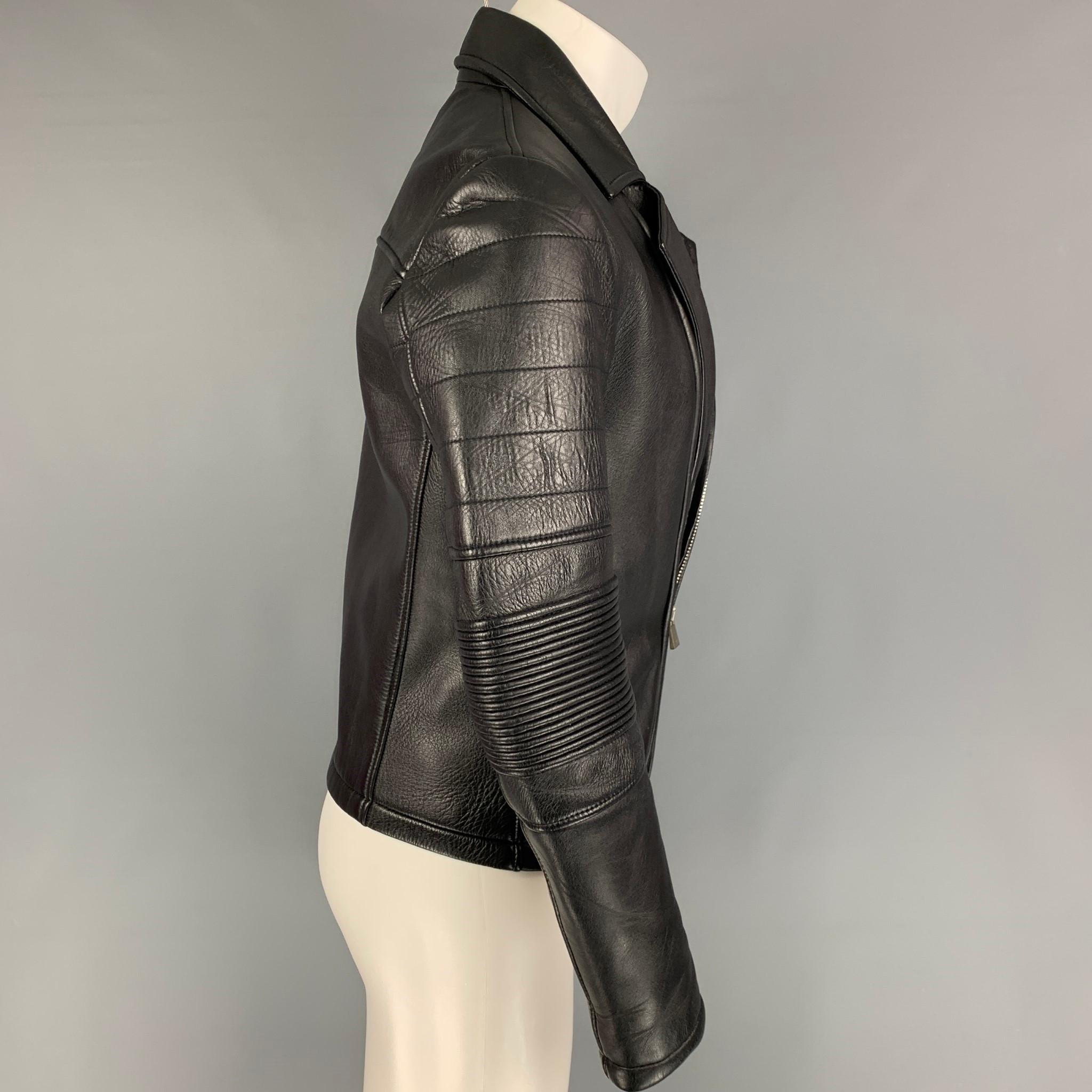 EMPORIO ARMANI jacket comes in a black leather featuring a biker style, ribbed arms, slit pockets, and a zip up closure. Made in Romania.

Very Good Pre-Owned Condition. Light mark at pocket. As-Is.
Marked: 46

Measurements:

Shoulder: 17.5