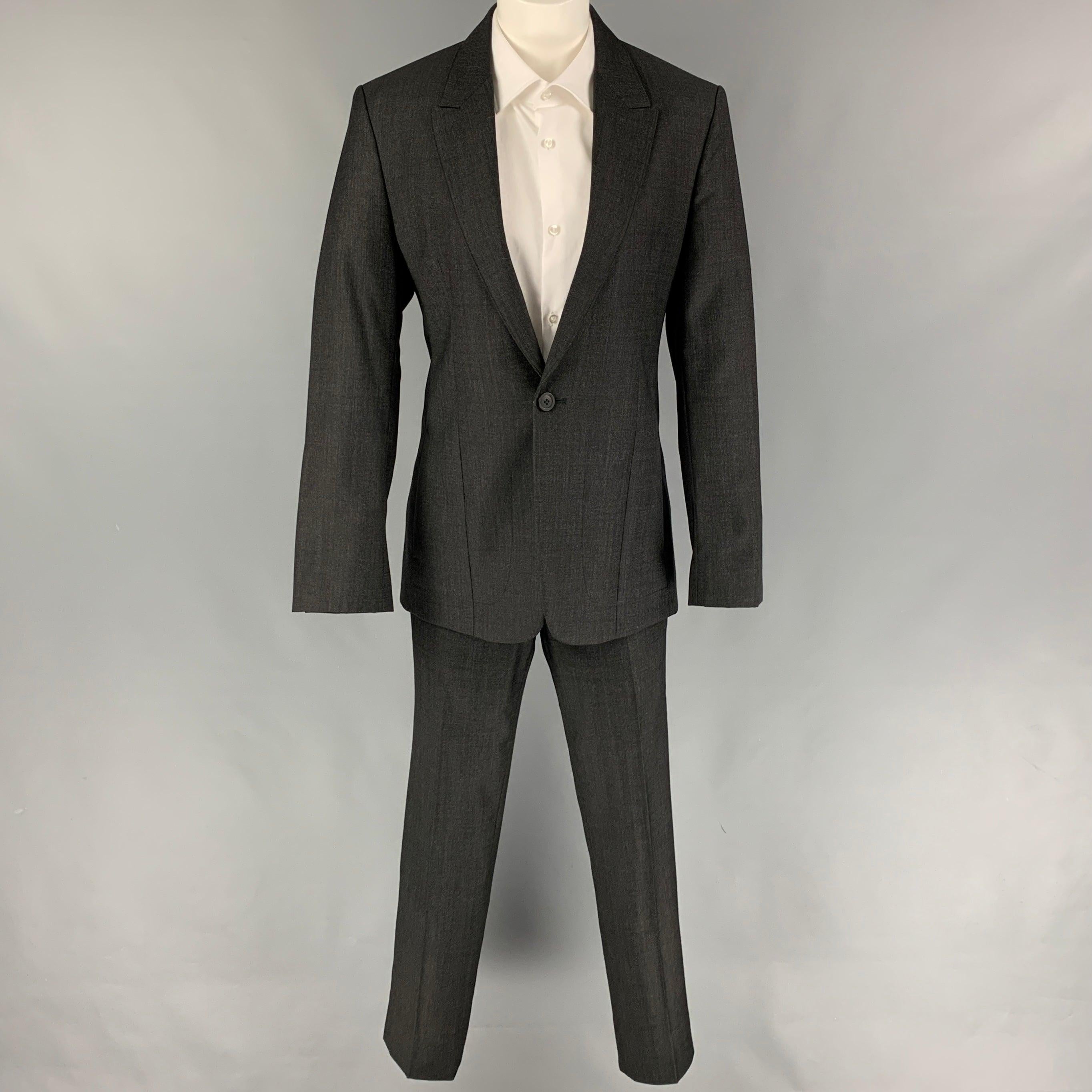 EMPORIO ARMANI
suit comes in a charcoal wool and includes a single breasted, single button sport coat with a peak lapel and matching flat front trousers. Made in Italy. Very Good Pre-Owned Condition. 

Marked:   46 

Measurements: 
 
