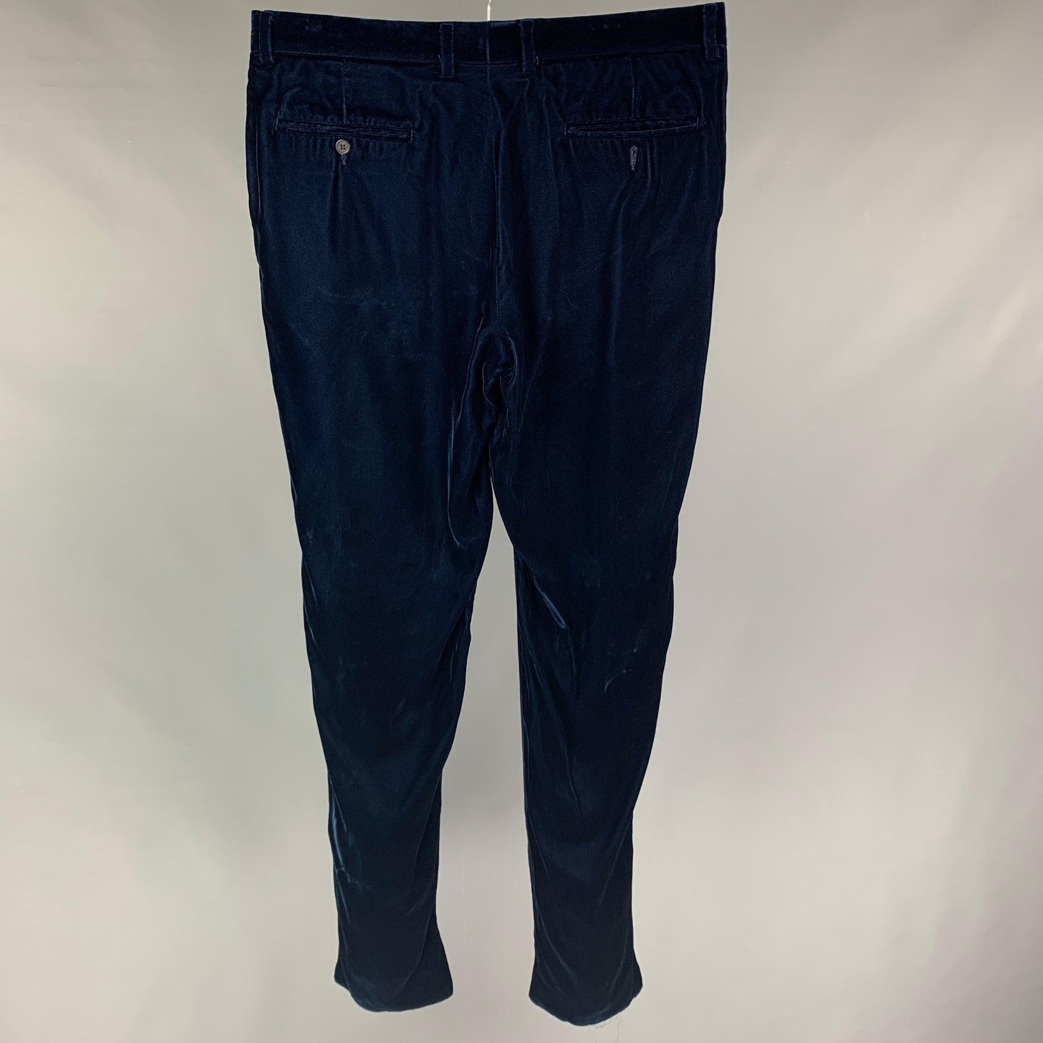 EMPORIO ARMANI dress pants comes in a navy velvet acetate blend featuring a slim fit, front tab, and a zip fly closure.
Very Good
Pre-Owned Condition. 

Marked:  52 

Measurements: 
 Waist: 36 inches Rise:
10.5 inches Inseam: 34 inches Leg Opening: