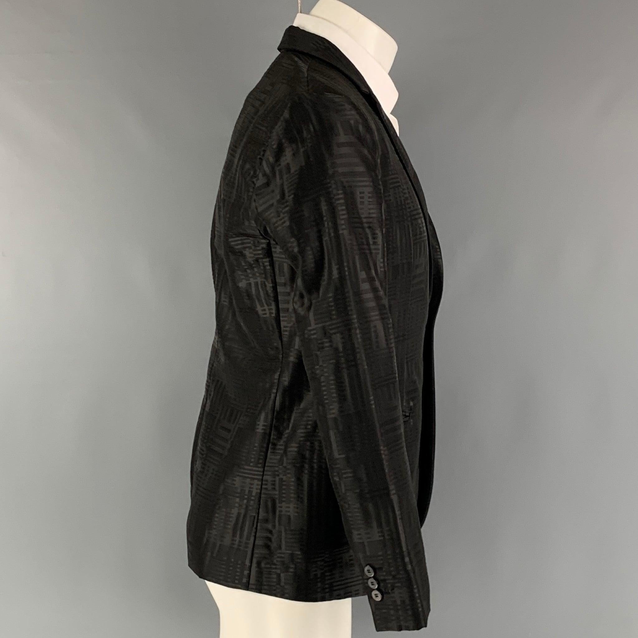EMPORIO ARMANI sport coat comes in black jacquard wool blend woven material with no lining featuring a notch lapel, welt pockets, and a single button closure. Made in Italy. Excellent Pre-Owned Condition. 

Marked:   48 

Measurements: 
 
Shoulder: