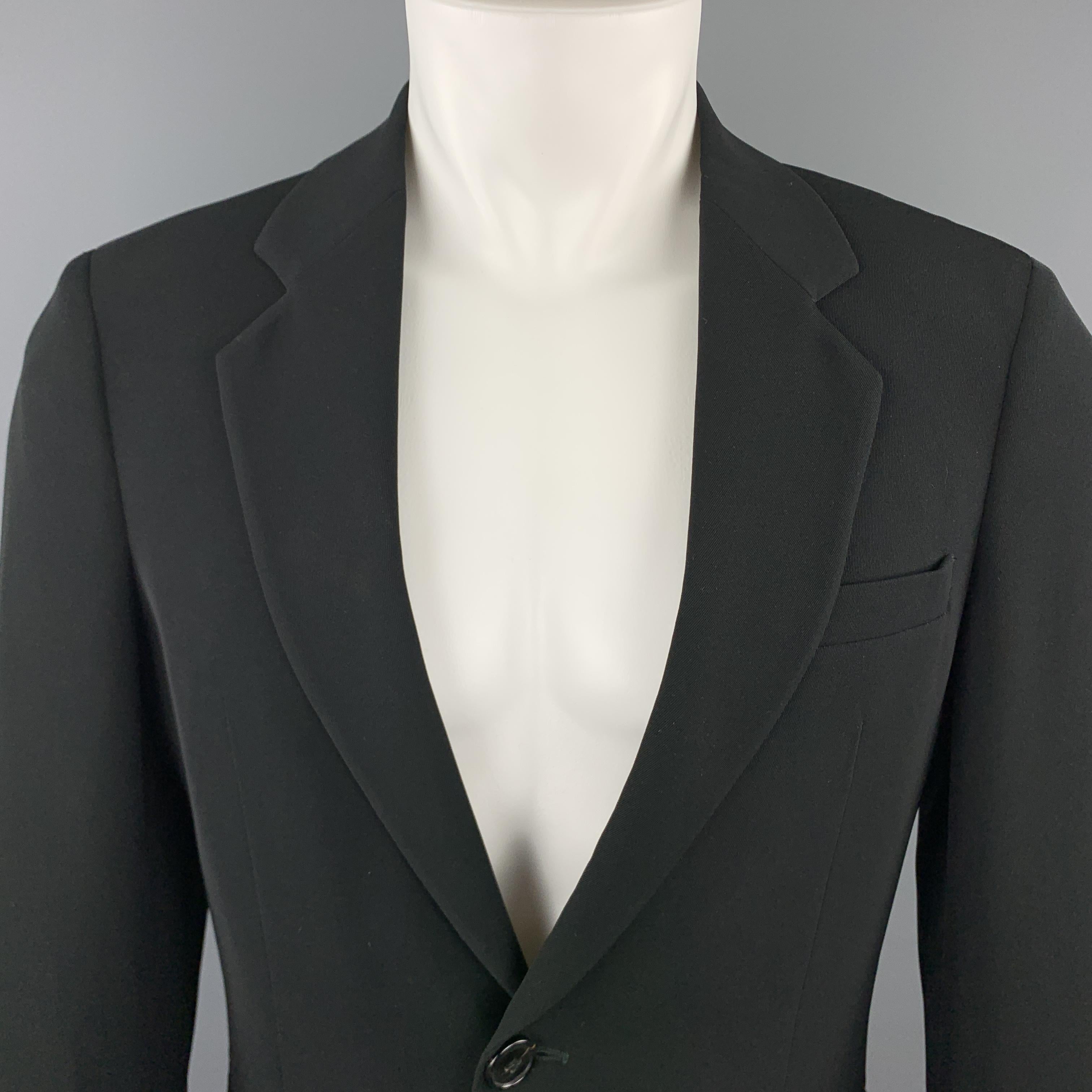 EMPORIO ARMANI sport coat comes in a solid black lightweight polyester material, with a notch lapel, slit pockets, two buttons at closure, single breasted,  buttoned cuffs, and a double vent at back. Made in Italy. 

Excellent Pre-Owned