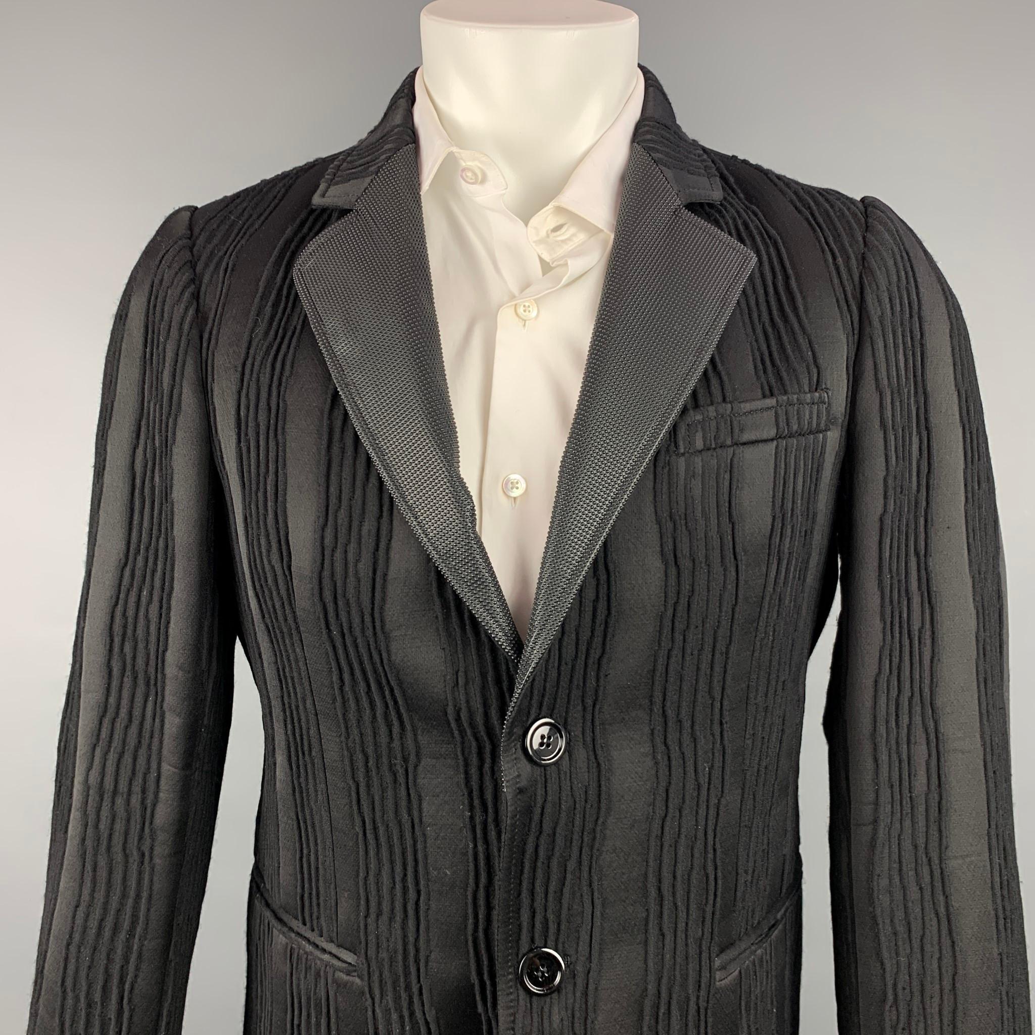 EMPORIO ARMANI sport coat comes in a black textured wool blend with a full liner featuring a rubber textured lapel, slit pockets, and a two button closure. Made in Italy.

Very Good Pre-Owned Condition.
Marked: IT 48

Measurements:

Shoulder: 17