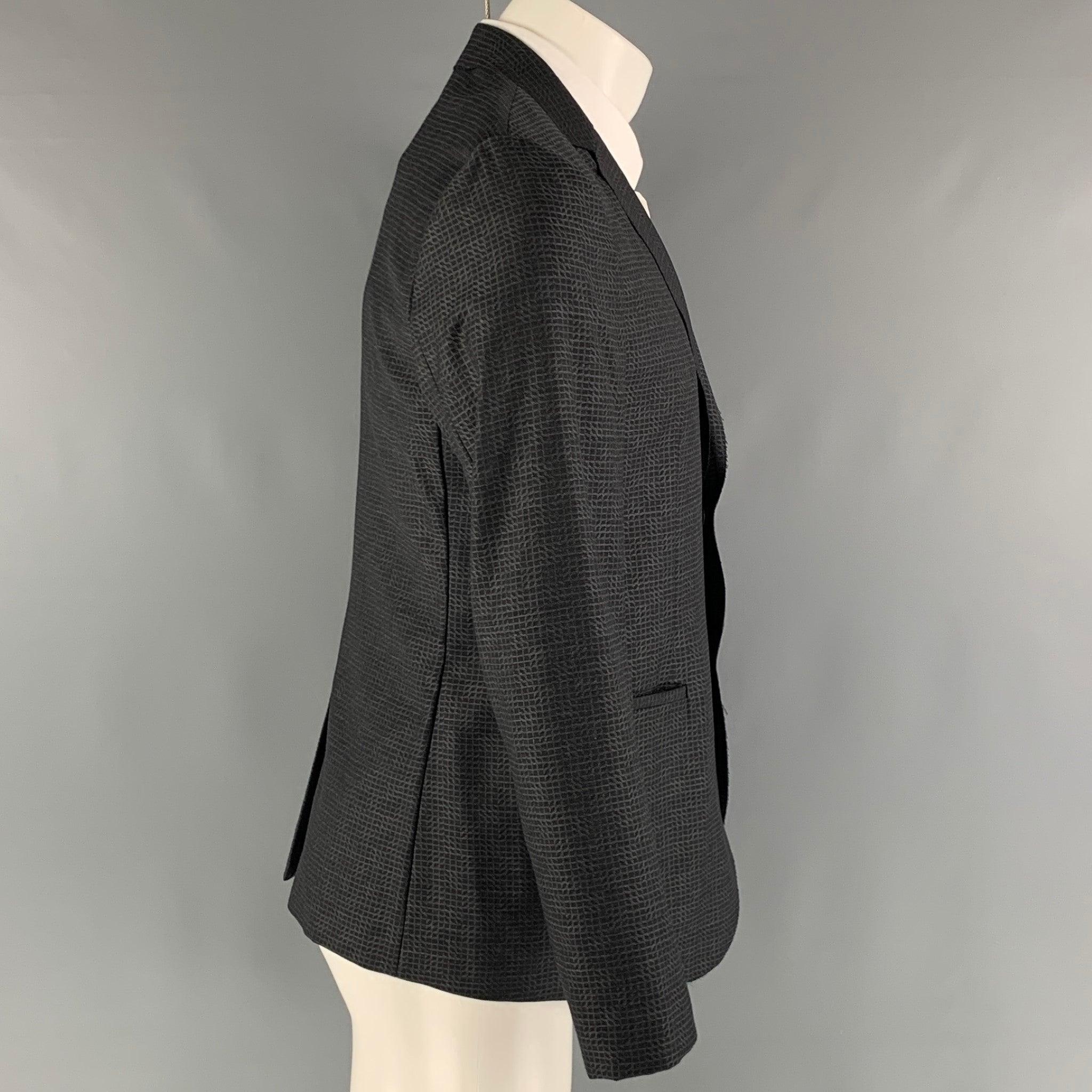 EMPORIO ARMANI sport coat comes in a charcoal and grey wool woven material no lining featuring a notch lapel, welt pockets, and a two snap button closure. Made in Italy. Excellent Pre-Owned Condition. 

Marked:   48 

Measurements: 
 
Shoulder: 16.5