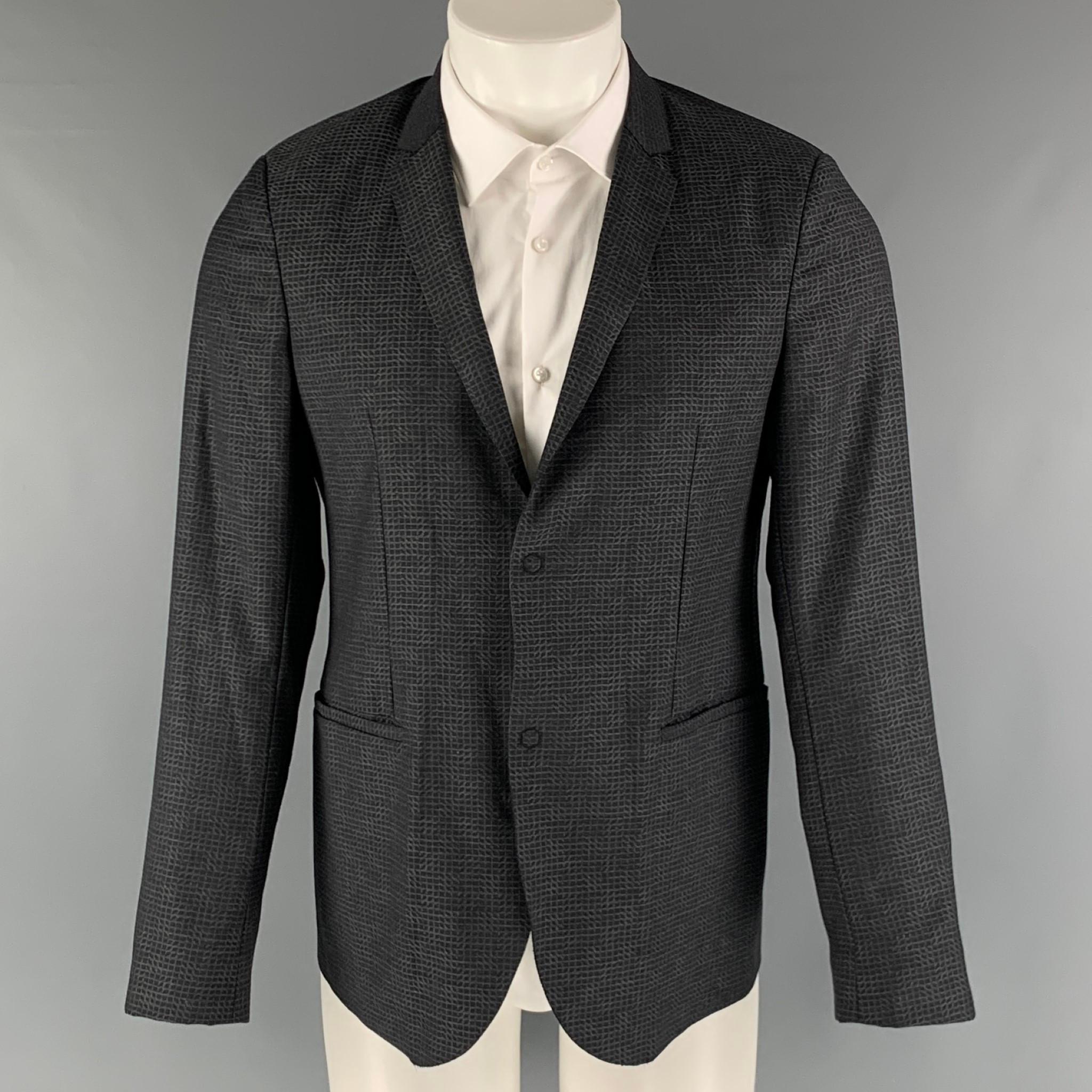 EMPORIO ARMANI sport coat comes in a charcoal and grey wool woven material no lining featuring a notch lapel, welt pockets, and a two snap button closure. Made in Italy.

Excellent Pre-Owned Condition.
Marked: 48

Measurements:

Shoulder: 16.5