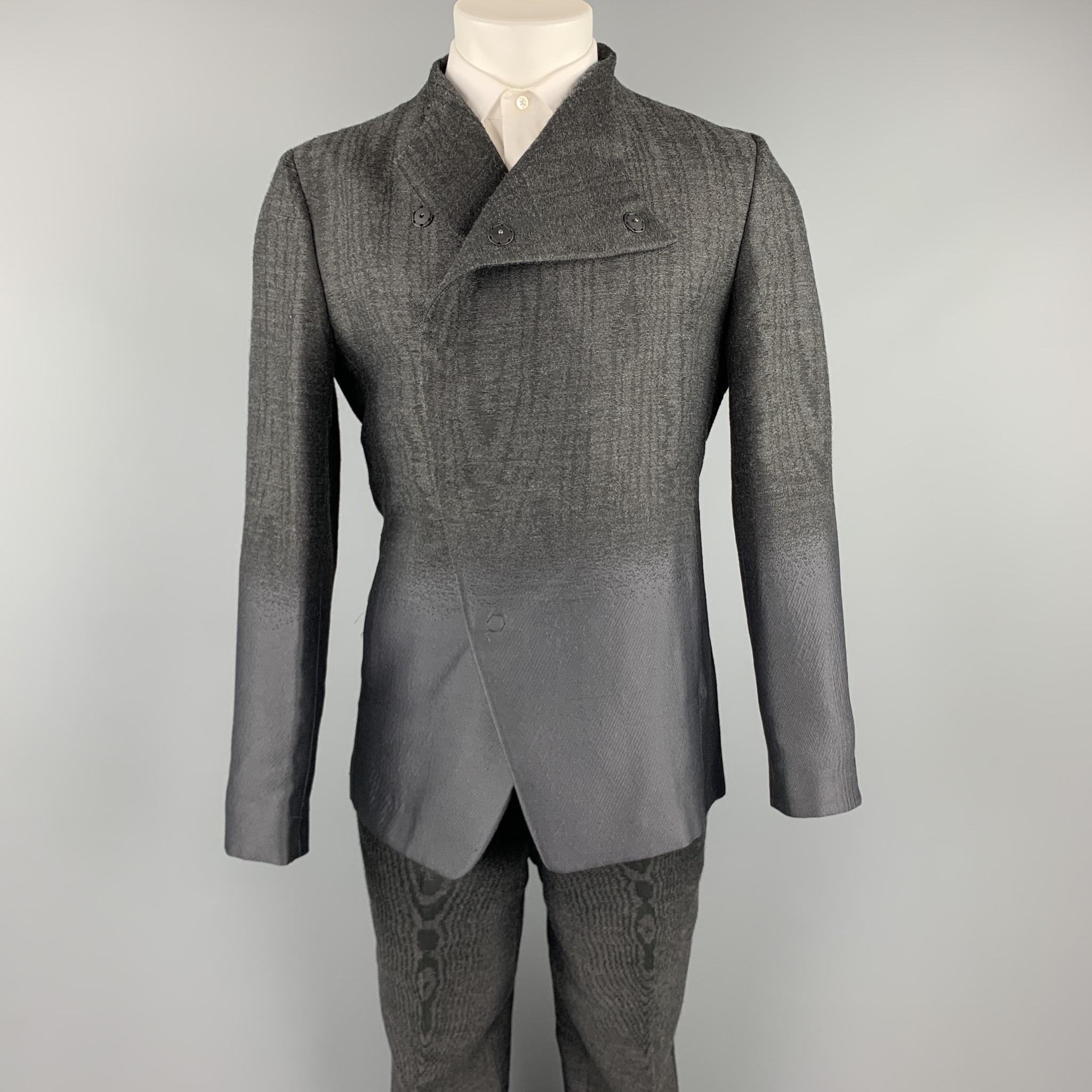 EMPORIO ARMANI suit comes in charcoal ombre with a half liner and includes an asymmetrical snap button sport coat with a collarless lapel and matching flat front trousers. Made in Italy.

Excellent Pre-Owned Condition.
Marked: IT