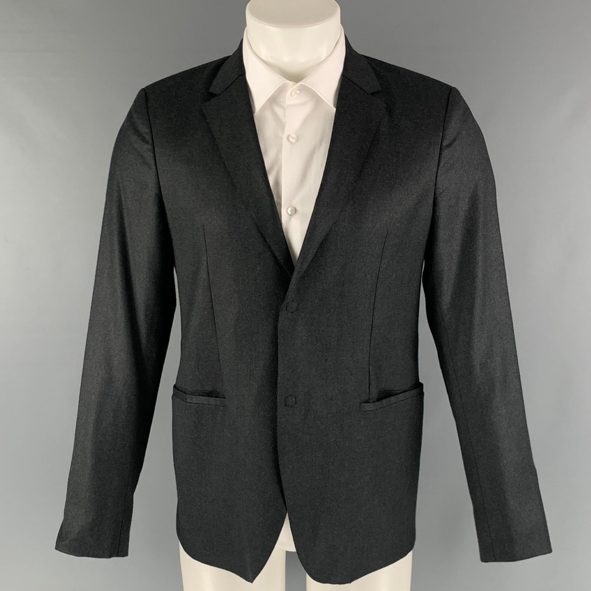 EMPORIO ARMANI 'MILANO' sport coat comes in a charcoal wool woven material with a full liner featuring a notch lapel, welt pockets, and a two snap button closure. Made in Italy.

Excellent Pre-Owned Condition.
Marked: 48

Measurements:

Shoulder: