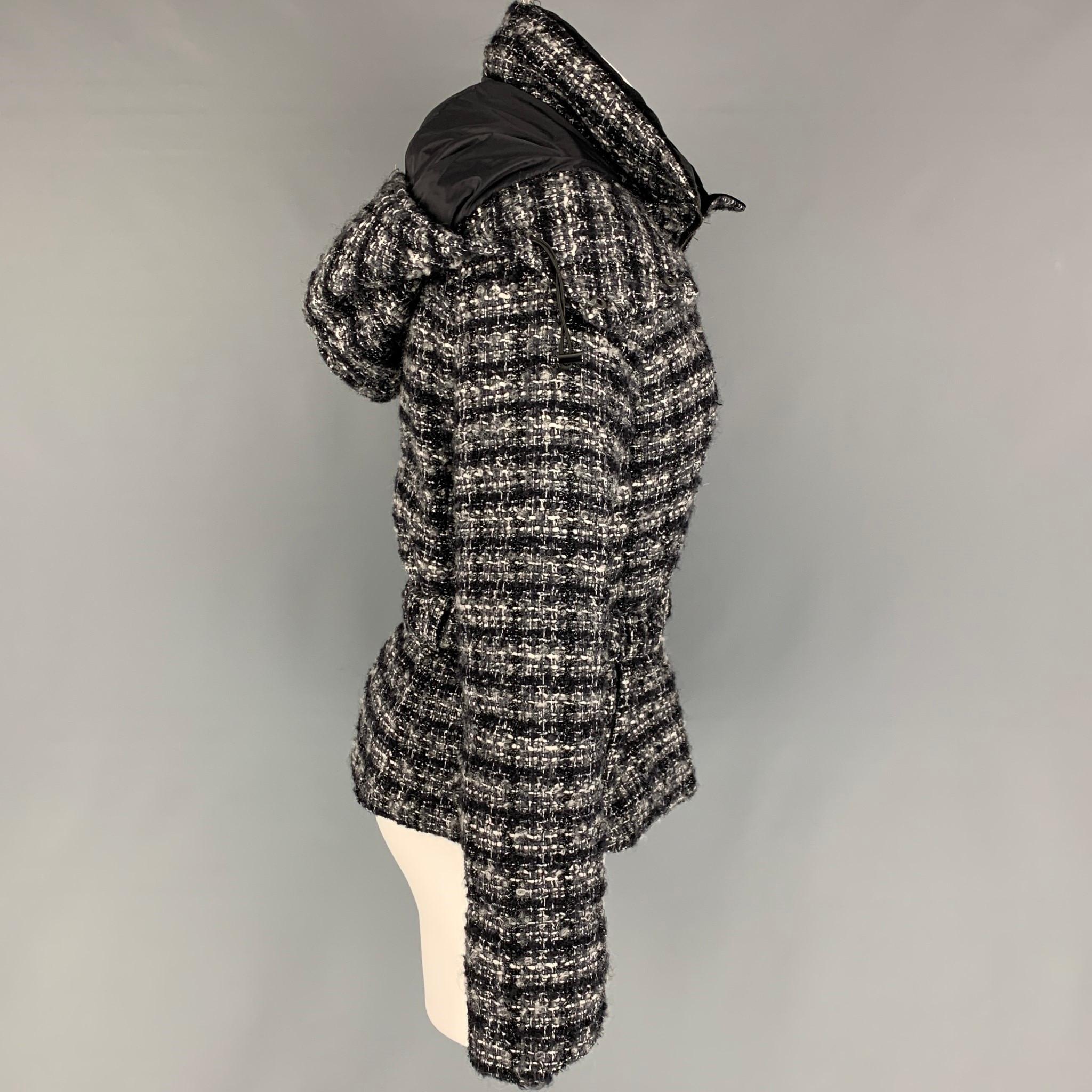 EMPORIO ARMANI jacket comes in a black & white woven wool featuring a hooded detail, belted, high collar, and a zip up closure. 

Very Good Pre-Owned Condition.
Marked: 40

Measurements:

Shoulder: 16 in.
Bust: 36 in.
Sleeve: 24.5 in.
Length: 22.5