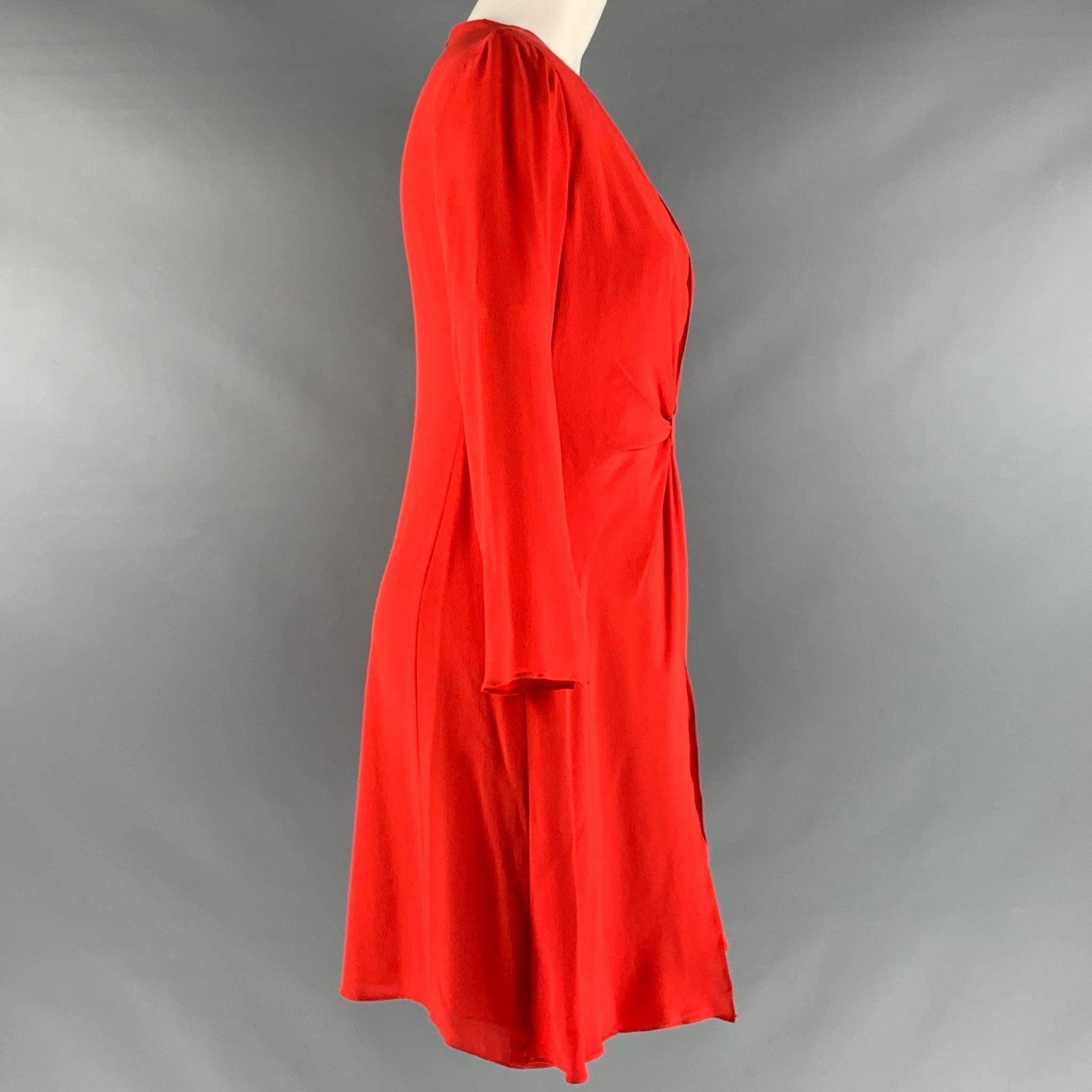 EMPORIO ARMANI
dress in a red silk fabric featuring a faux wrap style, V-neck, knee length, and back zipper closure.Very Good Pre-Owned Condition. Minor signs of wear. 

Marked:  40 

Measurements: 
 
Shoulder: 14.5 inches Sleeve: 20 inches Bust: 35