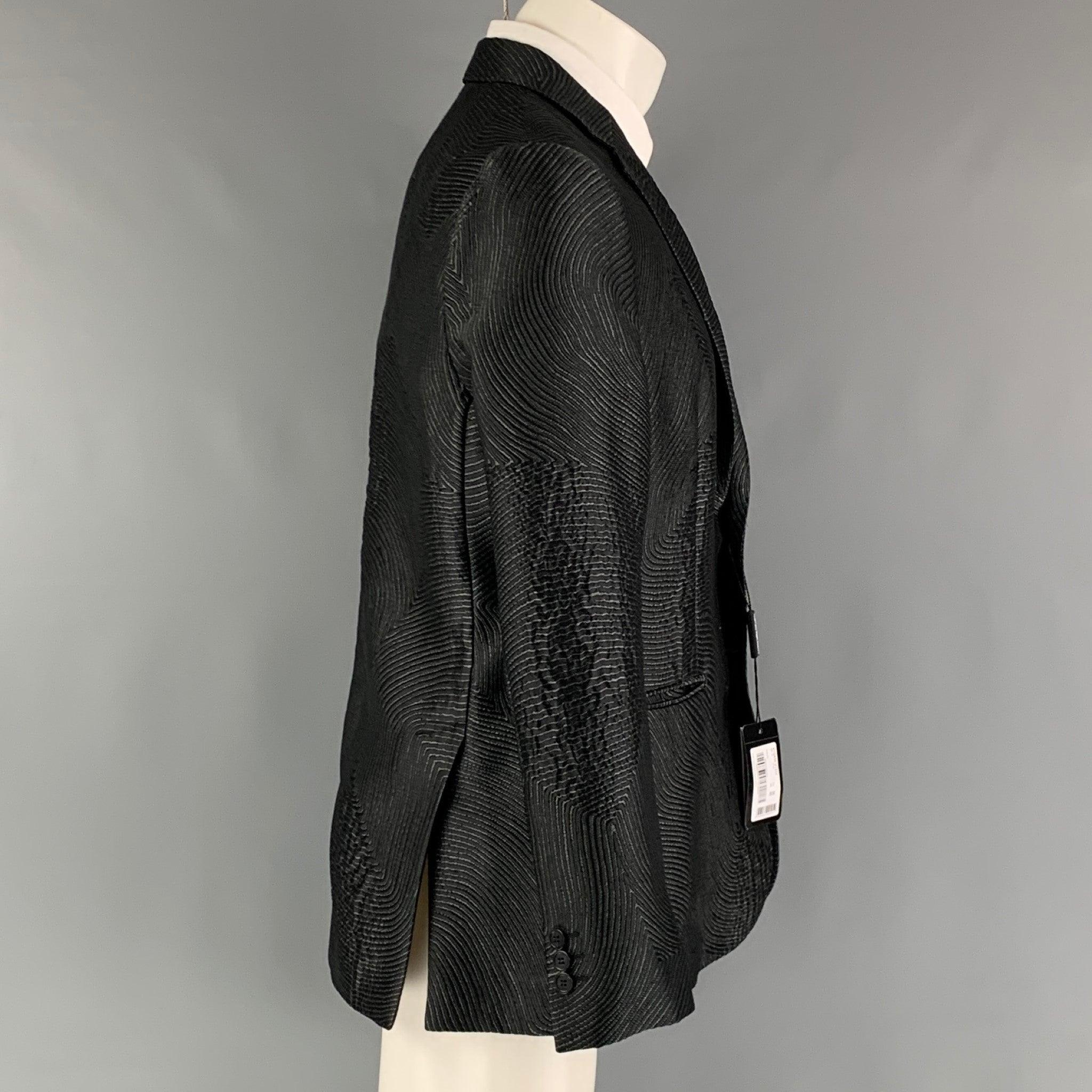 EMPORIO ARMANI sport coat comes in a black and grey jacquard polyester blend woven material with no lining featuring a notch lapel, welt pockets, and a two button closure. Made in Italy. New with Tags. 

Marked:   50 

Measurements: 
 
Shoulder: 17