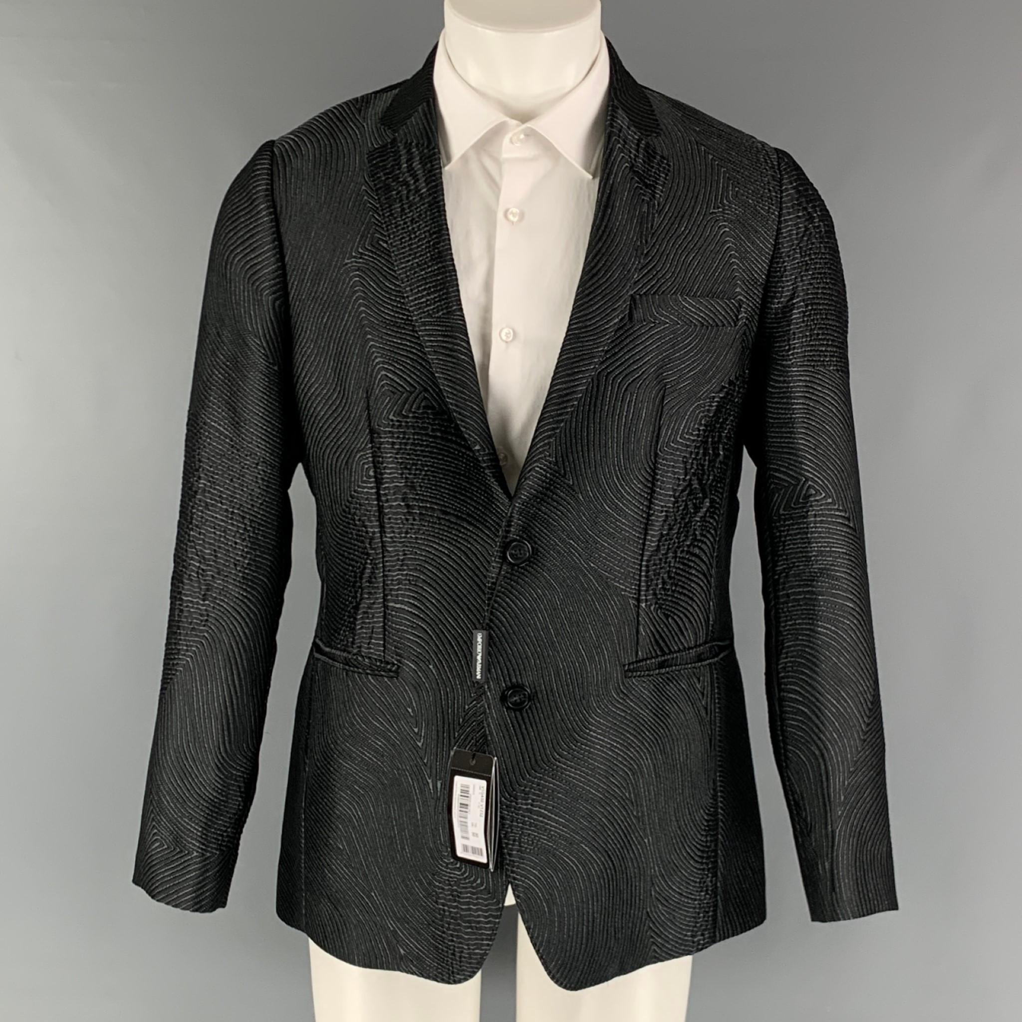 EMPORIO ARMANI sport coat comes in a black and grey jacquard polyester blend woven material with no lining featuring a notch lapel, welt pockets, and a two button closure. Made in Italy.

New with Tags.
Marked: 50

Measurements:

Shoulder: 17