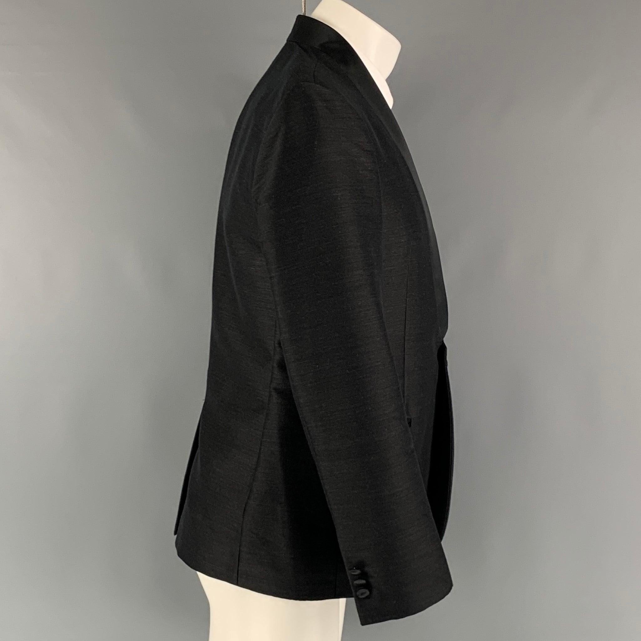 EMPORIO ARMANI 'Matt Line' sport coat comes in a black wool blend woven material full liner featuring a shawl collar, welt pockets, single back vent, and a single button closure. Made in Italy. Excellent Pre-Owned Condition. 

Marked:   50