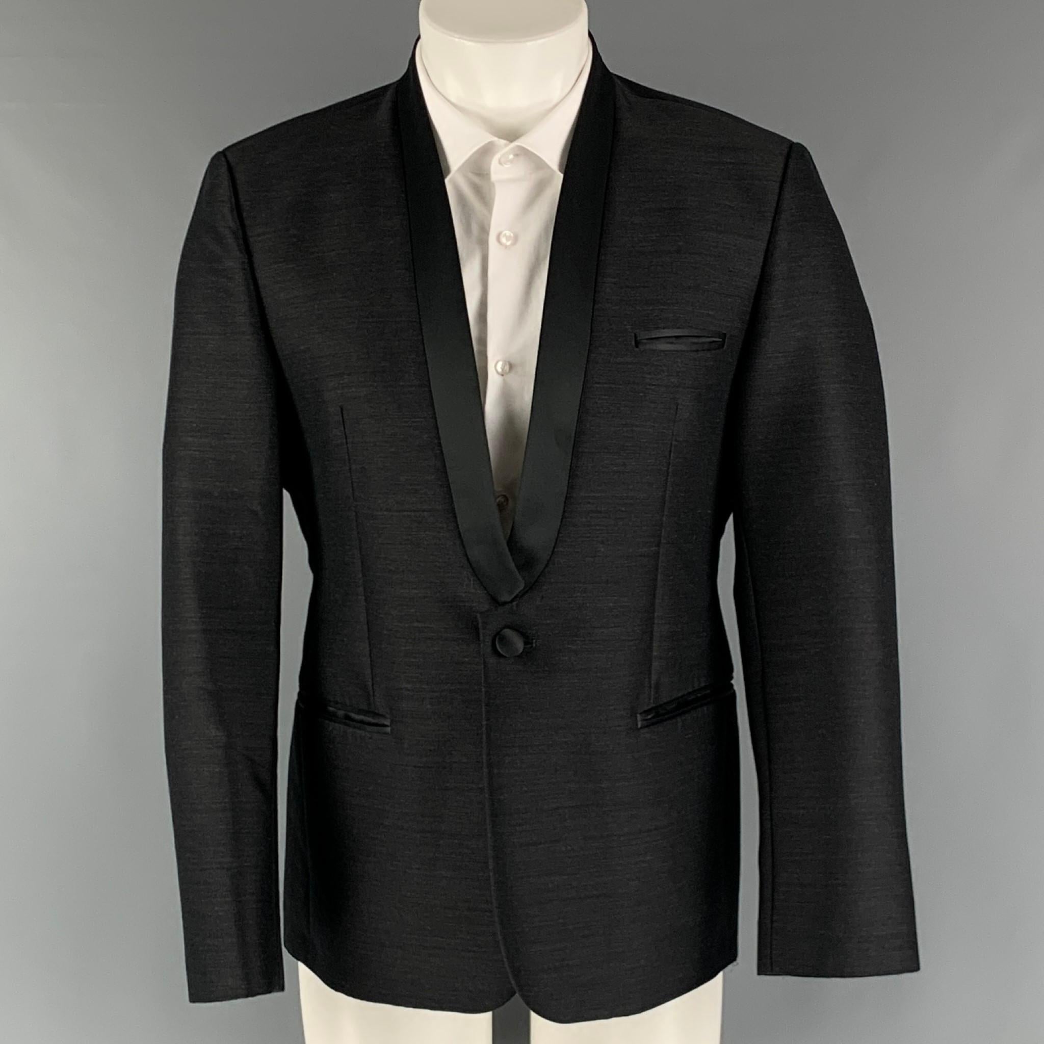 EMPORIO ARMANI 'Matt Line' sport coat comes in a black wool blend woven material full liner featuring a shawl collar, welt pockets, single back vent, and a single button closure. Made in Italy.

Excellent Pre-Owned Condition.
Marked: