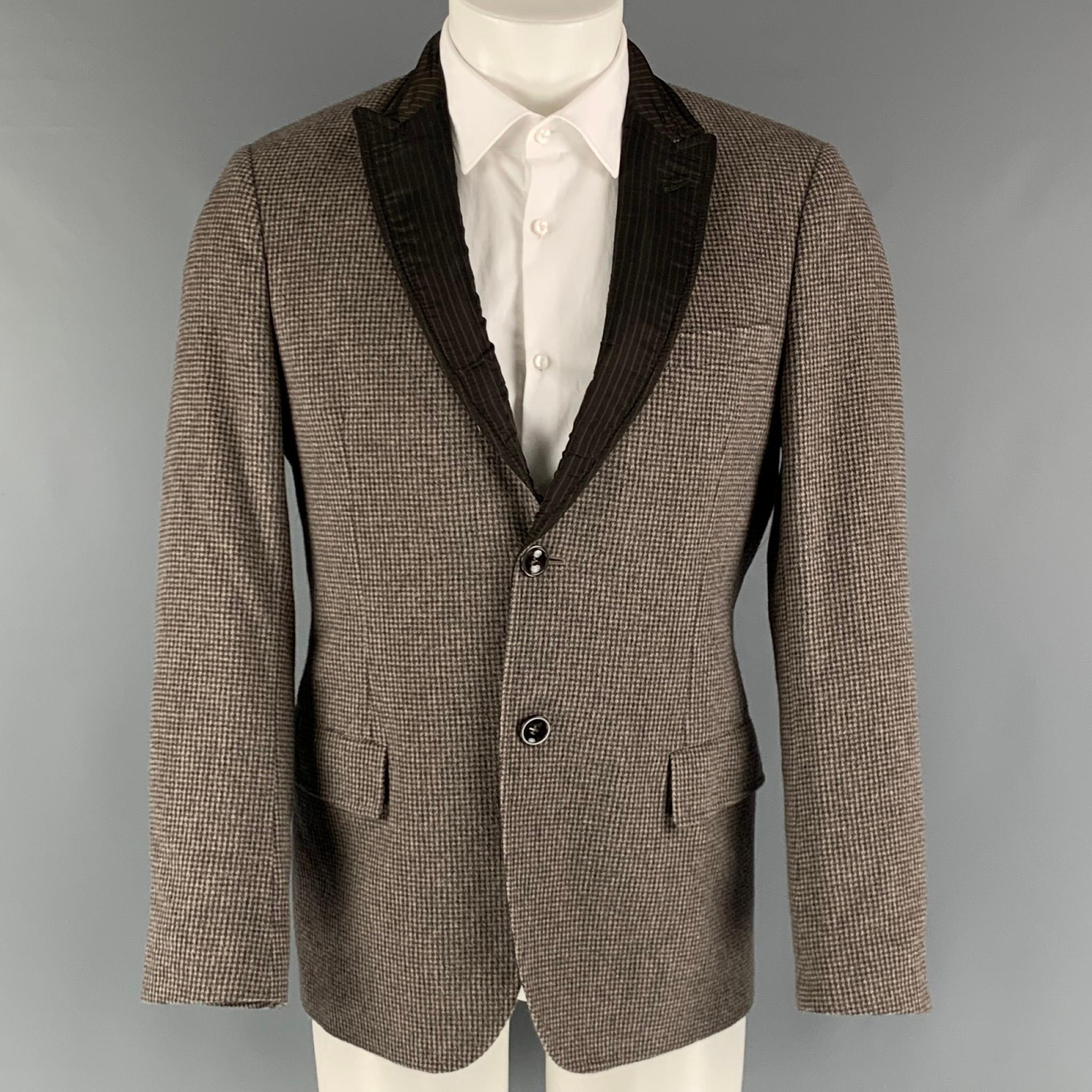 EMPORIO ARMANI sport coat comes in a brown, charcoal and grey checkered angora woven material with full lining featuring a peak lapel, patch pockets, and a two button closure. Made in Italy.

Excellent Pre-Owned Condition.
Marked: IT