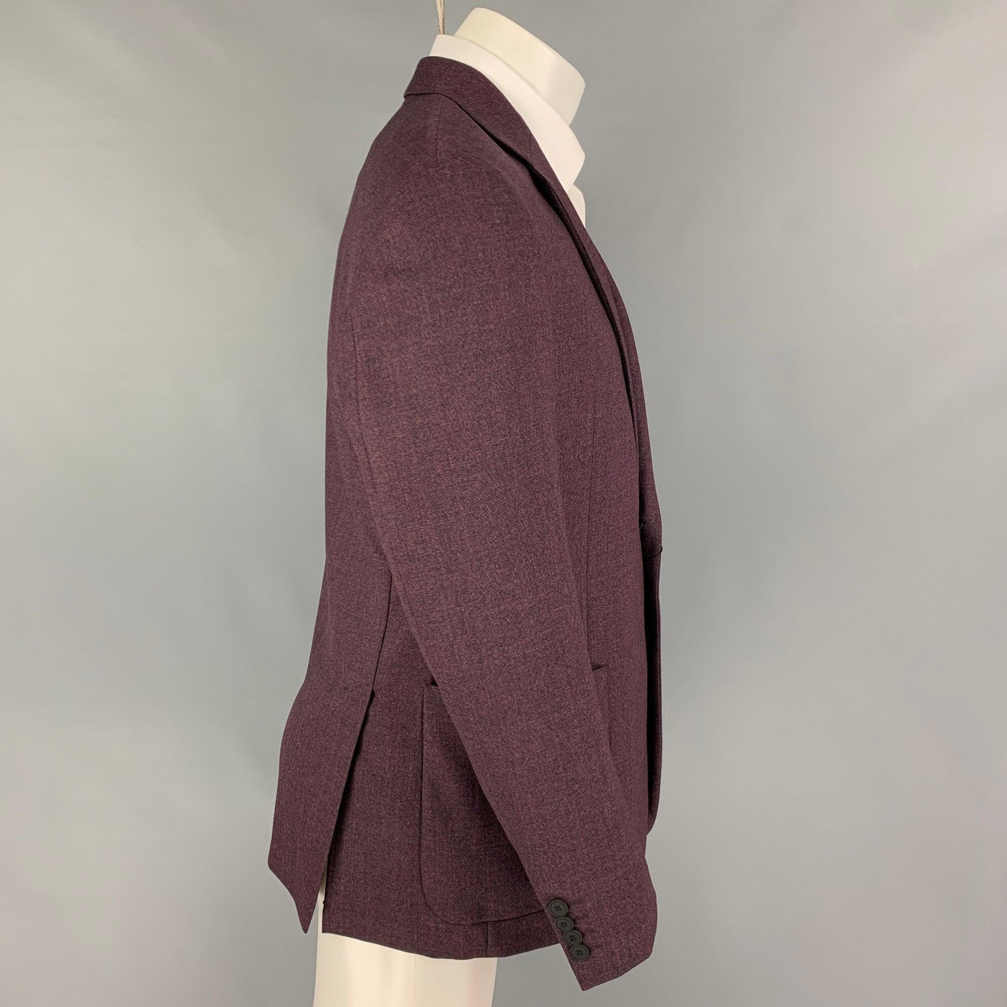 EMPORIO ARMANI sport coat comes in a purple heather wool with a half liner featuring a notch lapel, patch pockets, double back vent, and a double button closure.
New with tags.
 

Marked:   50 

Measurements: 
 
Shoulder: 18 inches  Chest: 40 inches