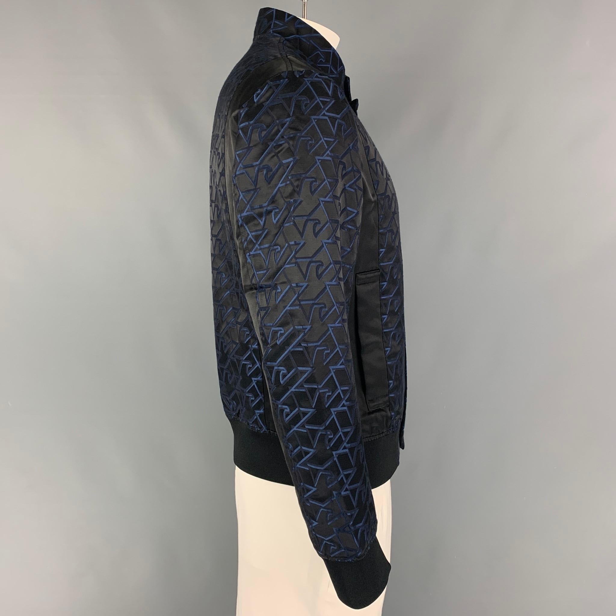 EMPORIO ARMANI jacket comes in a black & blue jacquard satin monogram print featuring a stand up collar, ribbed hem, slit pockets, and a hidden zip up closure. 

Excellent Pre-Owned Condition.
Marked: 52

Measurements:

Shoulder: 19 in.
Chest: 46