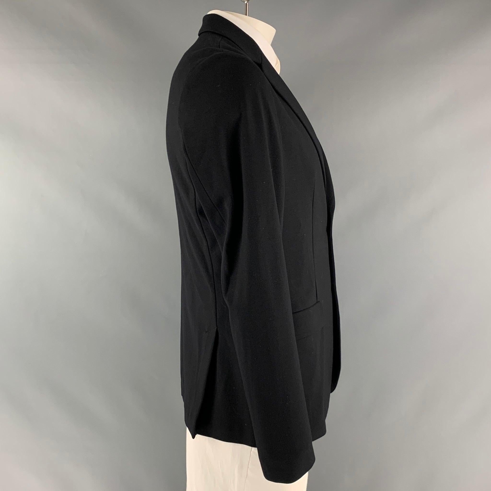 EMPORIO ARMANI sport coat comes in a black viscose blend knit material with no liner featuring a notch lapel, double back vent, and a double button closure. Made in Italy. Excellent Pre- Owned Condition. 

Marked:   52 

Measurements: 
 
Shoulder: