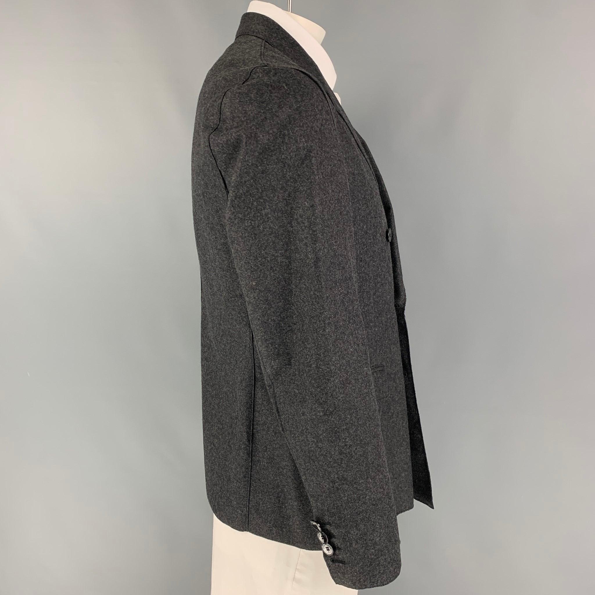 EMPORIO ARMANI coat comes in a charcoal heather wool / polyamide featuring a notch lapel, flap pockets, single back vent, and a double breasted closure. Made in Italy.
Very Good
Pre-Owned Condition. 

Marked:   52 

Measurements: 
 
Shoulder: 18.5
